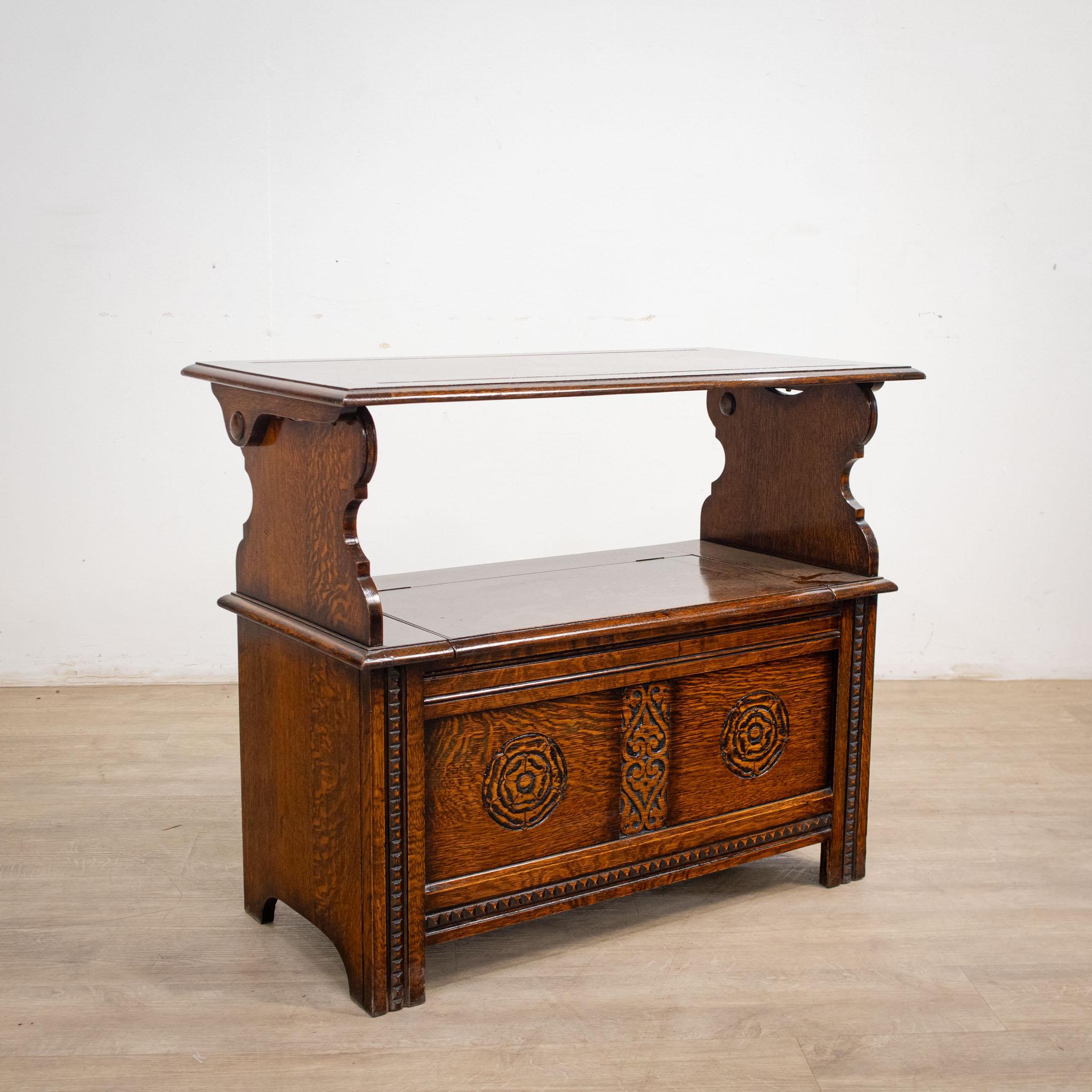 A lovely, compact 'metamorphic' monks bench in well grained oak with restrained carved detail.

-Features a flip over lid, which functions as a table or bench back rest when in a vertical position.
-Discreet storage with a lift up seat. A good
