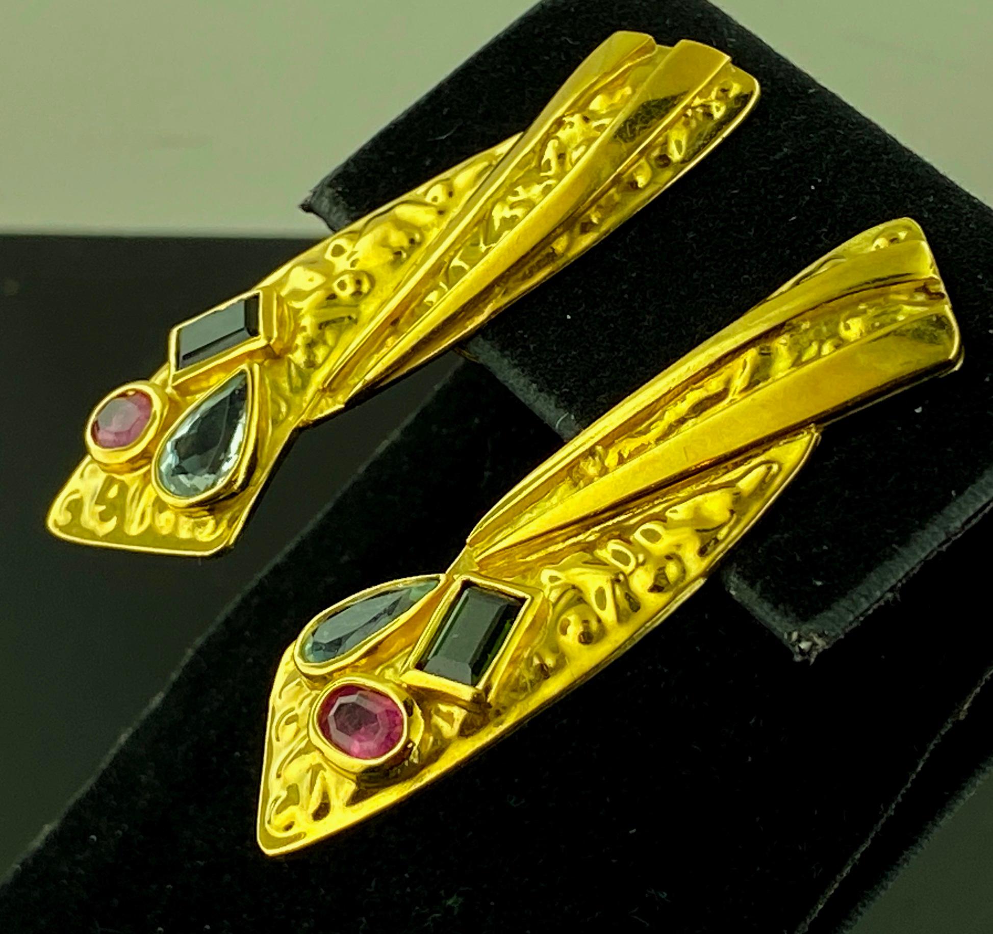 Set in 18 karat yellow gold, weighing 13 grams, are drop down earrings with one Oval Pink Sapphire, one Pear shaped Aquamarine and one Emerald cut Peridot in each earring. 