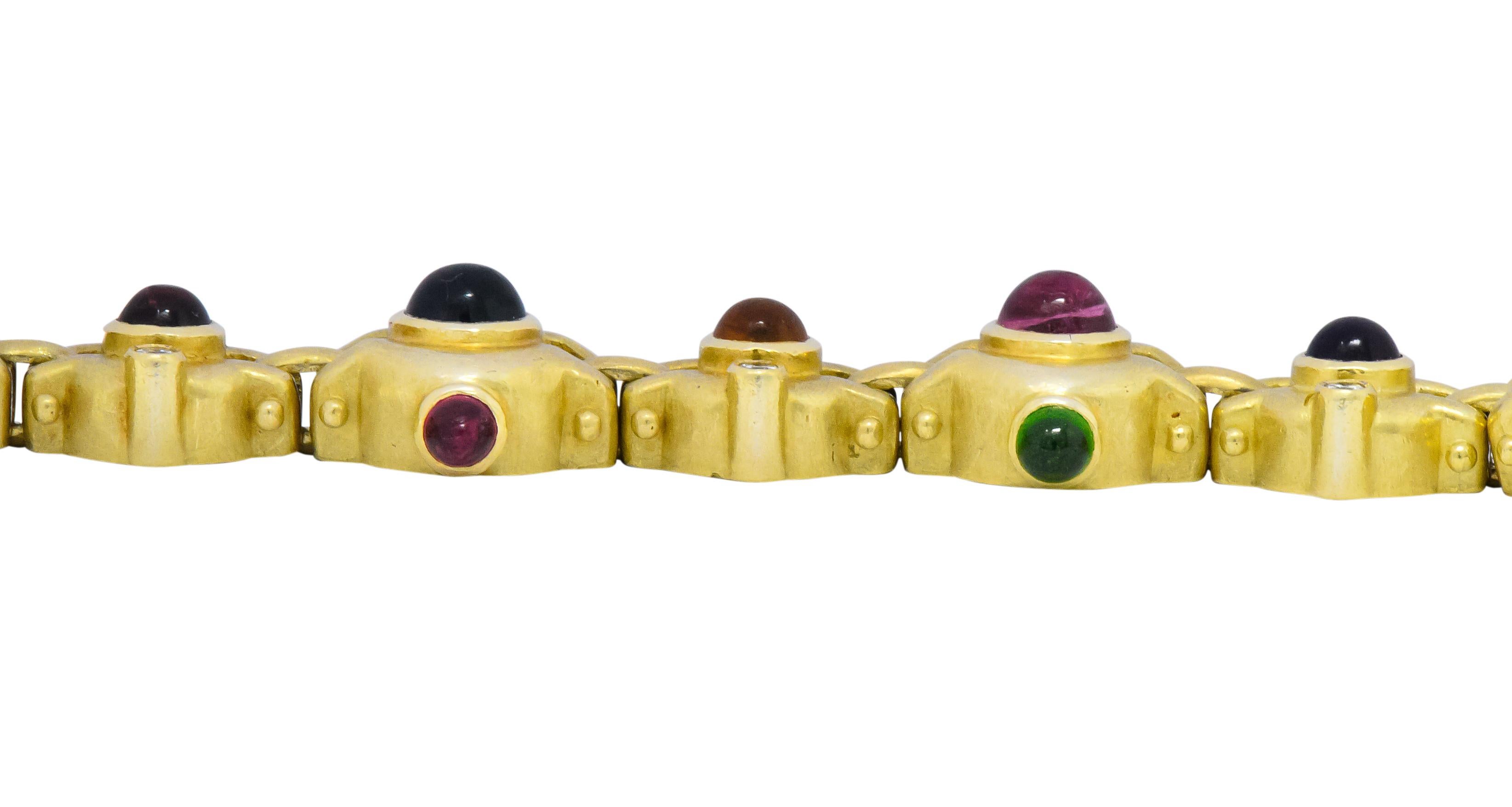 Each link centering a round cabochon gemstone with smaller round cabochon gemstone accents

Including amethyst, citrine, tourmaline, peridot and iolite

Accented by round brilliant cut diamonds, weighing approximately 0.50 carat total, G/H color and