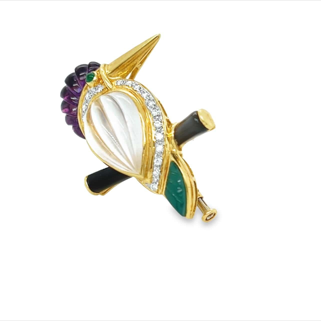 Intricately crafted gemstone and diamond parrot bird brooch. The detail and craftsmanship used in making this piece is substantial. The Rock Crystal Quartz body of the bird, Amethyst head and Chalcedony tail are all etched gems. The bird is made an