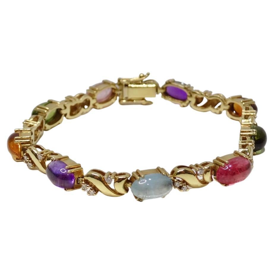 Get your hands on this link fashion bracelet circa 1980s containing 27 full cut diamonds and 9 oval cabachon gemstones as follows: 2 pink
tourmalines, 2 green tourmalines, and 1 aquamarine. Bracelet measures approx. 6.5MM with box clasp and