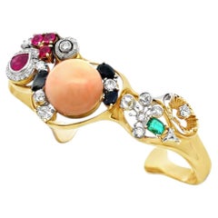 Bracelet manchette orné de plusieurs pierres précieuses, de corail et de diamants