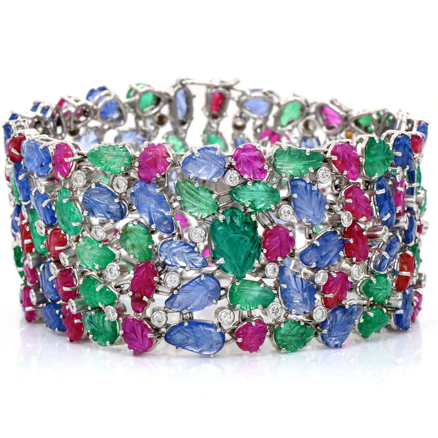 This Estate bracelet of highly ornate, vividly colored aesthetic is crafted in solid 18K white gold. This wide, articulated strap-designed bracelet in the Mogul style as a meandering vine pavé-set with round-cut diamonds, bearing a profusion of