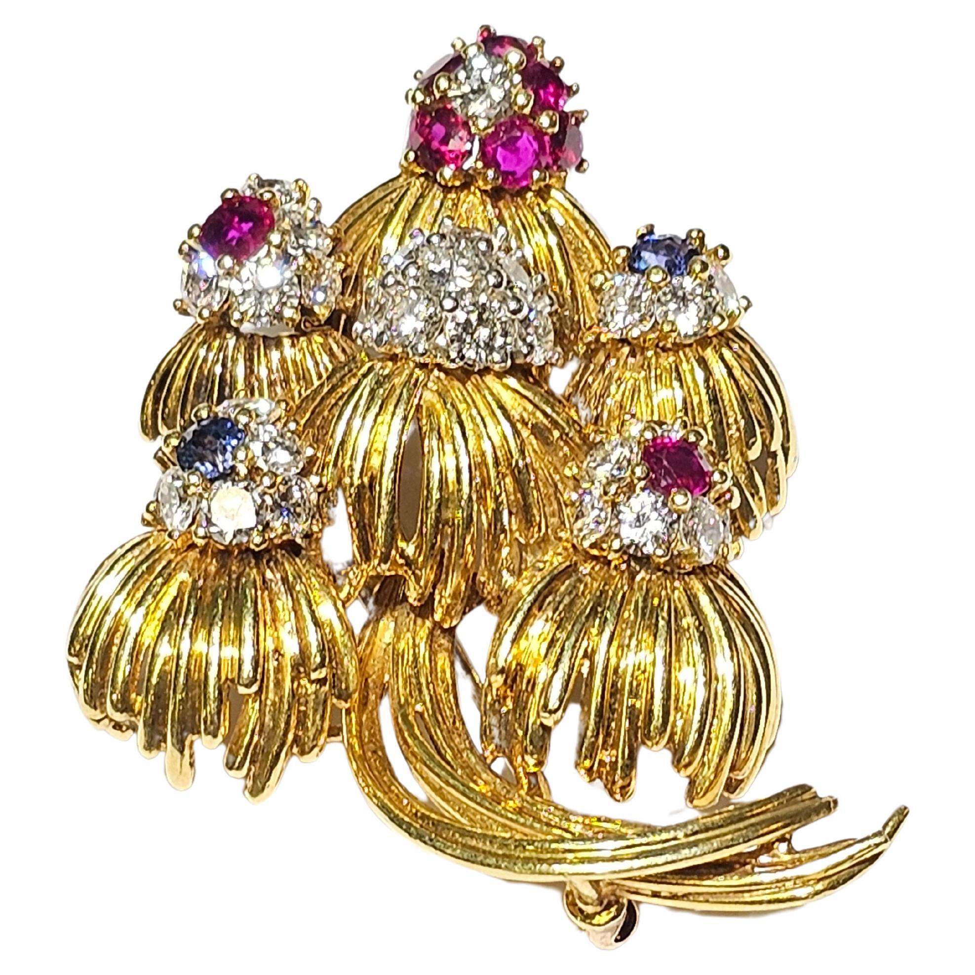 Multi Gem Floral Brooch

An 18-karat yellow gold brooch set with 33 round cut diamonds, 9 round cut rubies, and 2 round cut sapphires

Stamped 18K

Measurements: 1.88