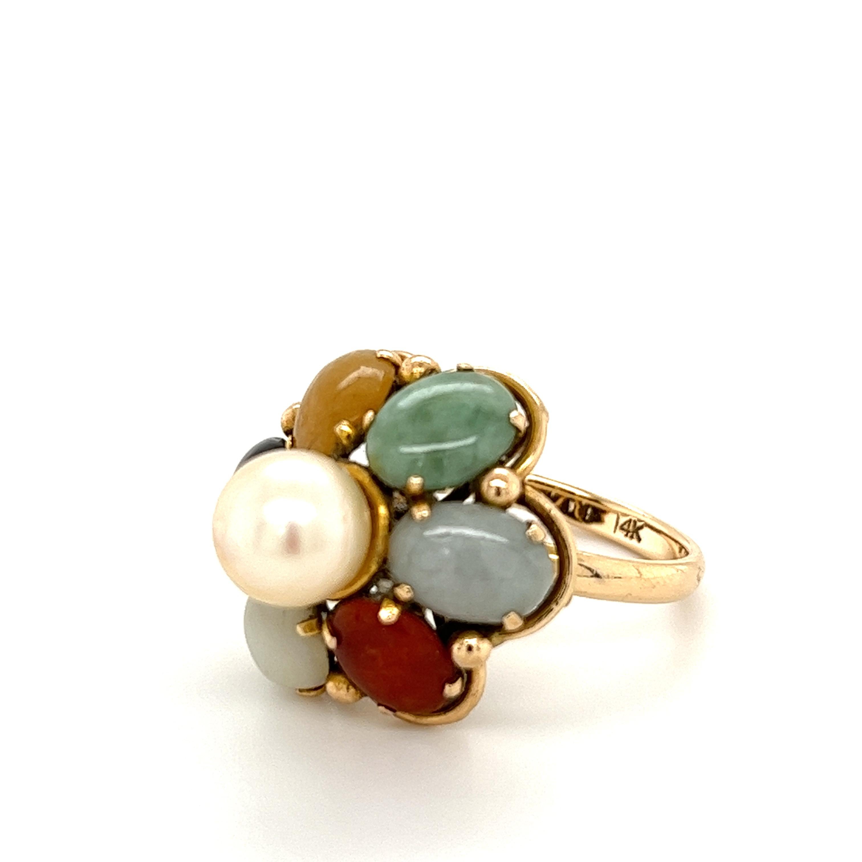 Multi-gemstone cluster style flower ring in 14k solid yellow gold. Featuring a lustrous pearl center stone, and is accompanied by coral, onyx, opal, and jade. This vintage ring was handmade in a gorgeous flower-style setting with different gemstones