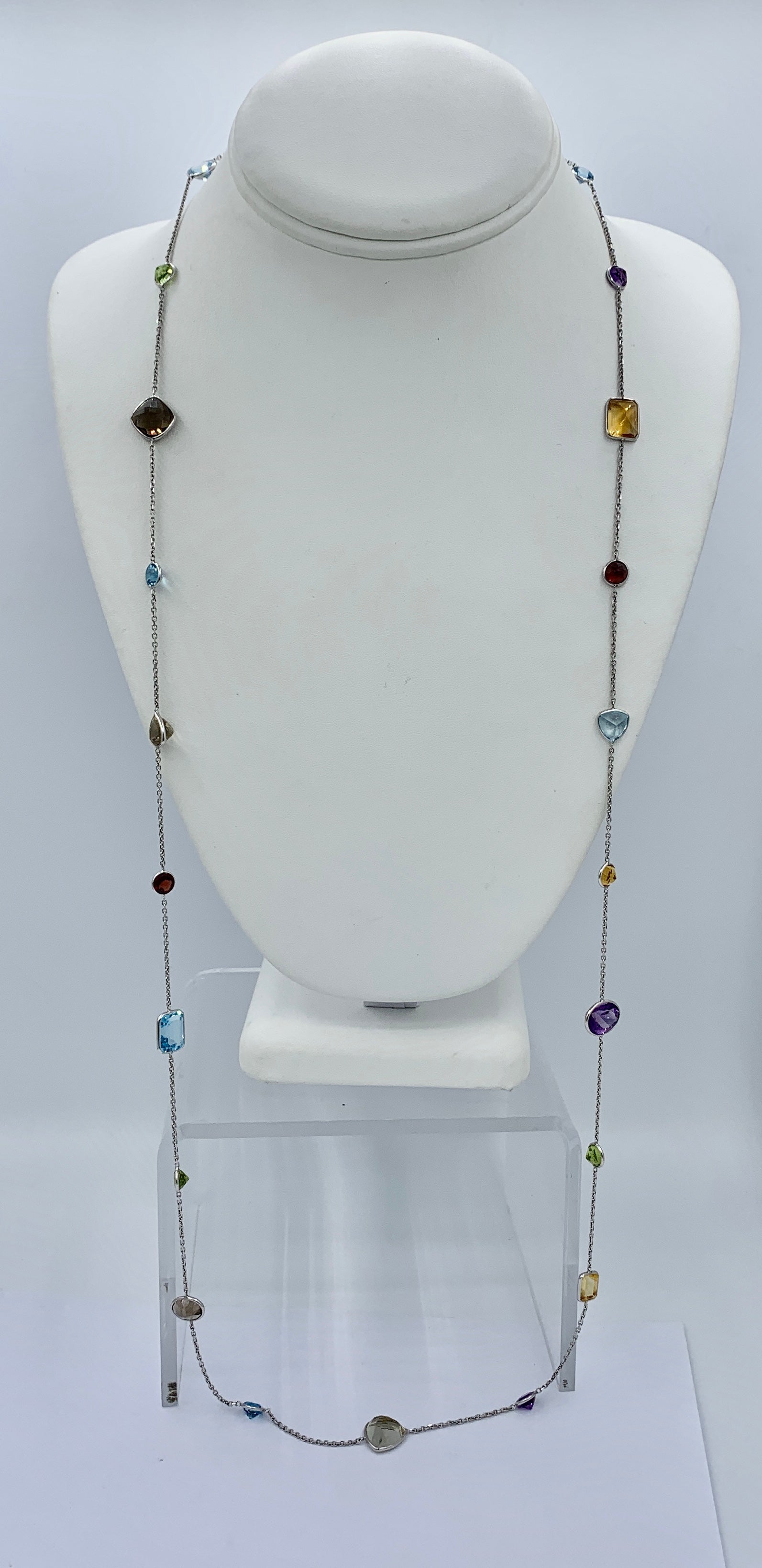 We are so delighted to have this iconic 36 inch Multi Gem Sautoir Station Necklace with Amethyst, Citrine, Garnet, Topaz and Peridot Gems of varying cuts and sizes all bezel set and arrayed in a 14 Karat White Gold By The Yard design.  The 22