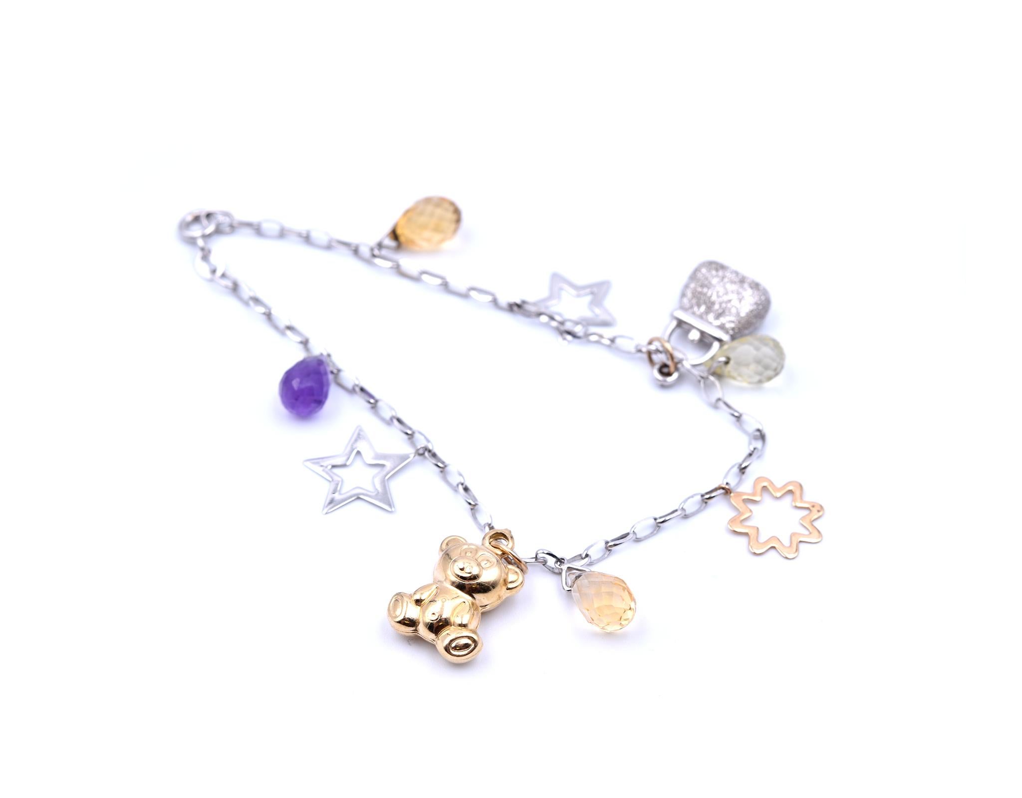 Designer: custom design
Material: 14k white & yellow gold
Gemstone: citrine, amethyst and prasiolite
Charms: star, purse, flower and teddy bear
Dimensions: bracelet is 6 3/4-inch long, each charm drops 1/2-inch
Weight: 6.05 grams
