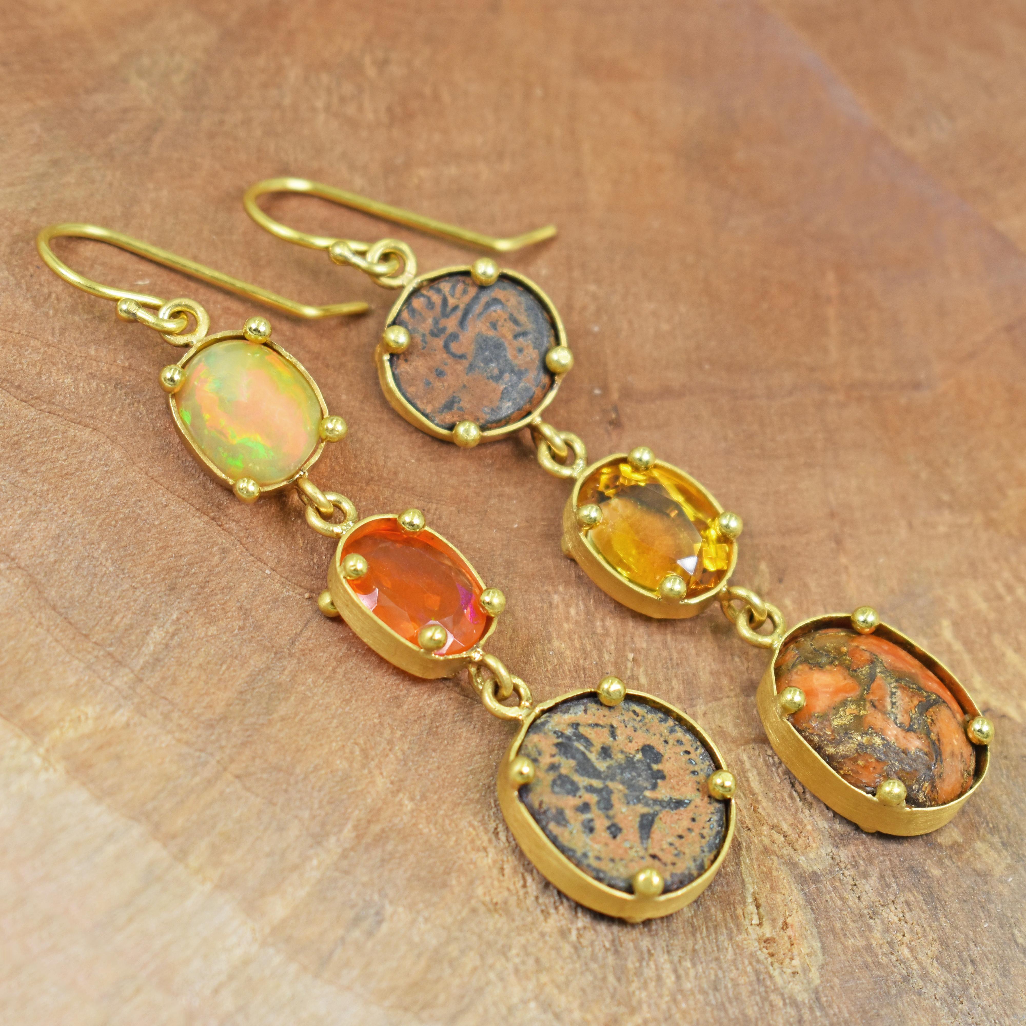 Unique, multi-gemstone and authentic ancient Greek bronze coins (3rd to 1st century AD) set in 22k yellow gold asymmetrical dangle earrings. Earrings feature Ethiopian Opal, Jasper, Citrine and Fire Opal gemstones. Greek coins have a brownish
