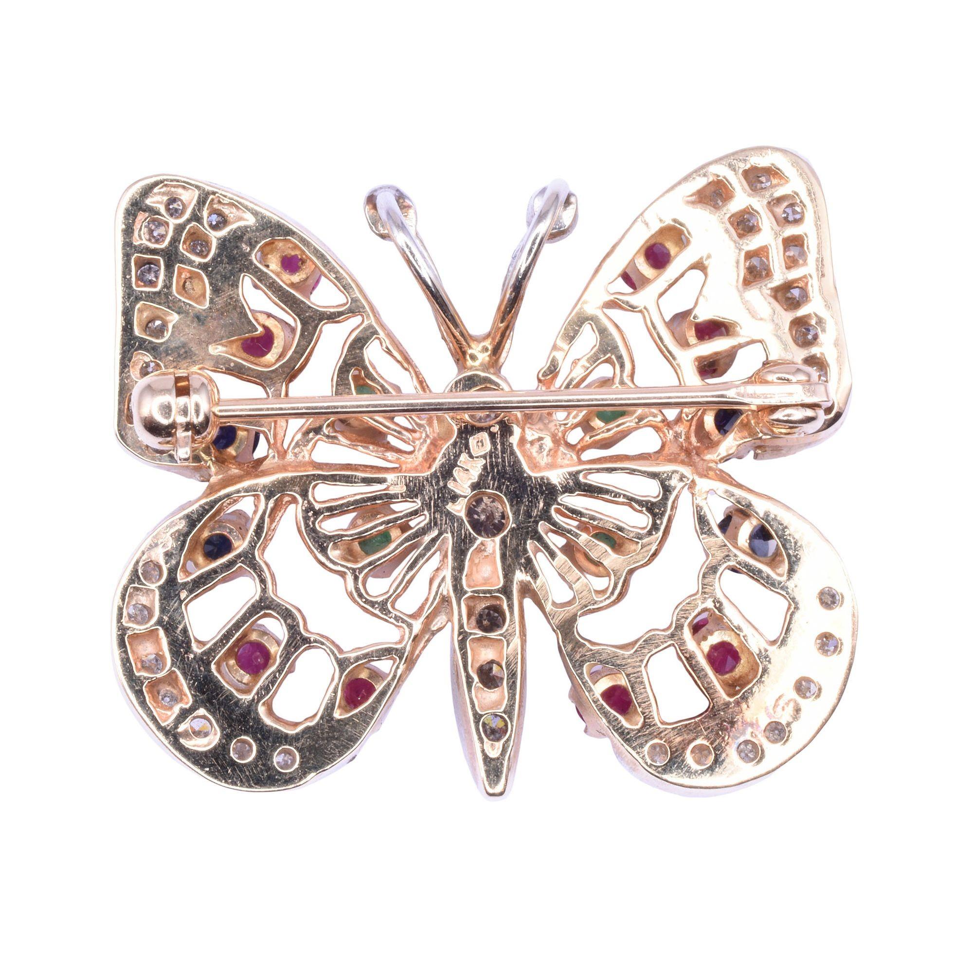 Estate multi gemstone butterfly pin or pendant. This 14 karat yellow gold butterfly may be worn as a pin or pendant. This butterfly is full of color featuring .30 CTW of rubies, .14 CTW of emeralds, .22 CTW of sapphires, and .40 CTW of diamonds