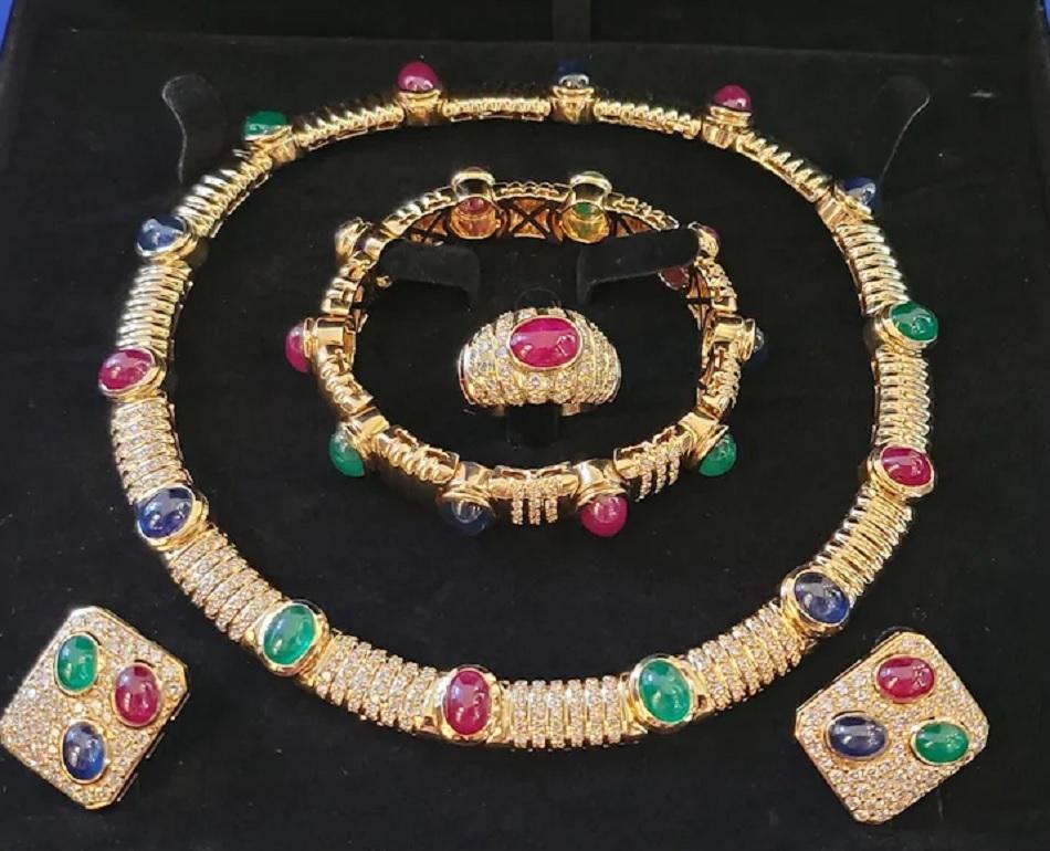 Multi Gemstone Choker Necklace, Ring, Bracelet, and Earring Matching Set set in 18K Yellow Gold. Necklace: 5 Oval Cabochon Natural Rubies equal 15.75ct. 5 Cabochon Natural Sapphires total 13.75 carats. 3 Oval Cabochon Natural Emeralds equal 6.60