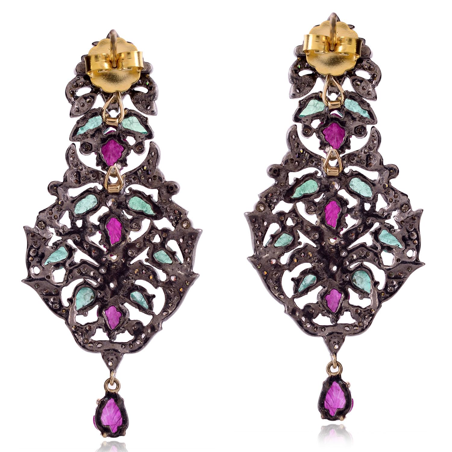 The earrings are adorned with Emerald , Ruby and pave diamonds, which are small diamonds that are set closely together in a surface, giving the appearance of a continuous surface of sparkling diamonds. These earrings are likely to be quite beautiful