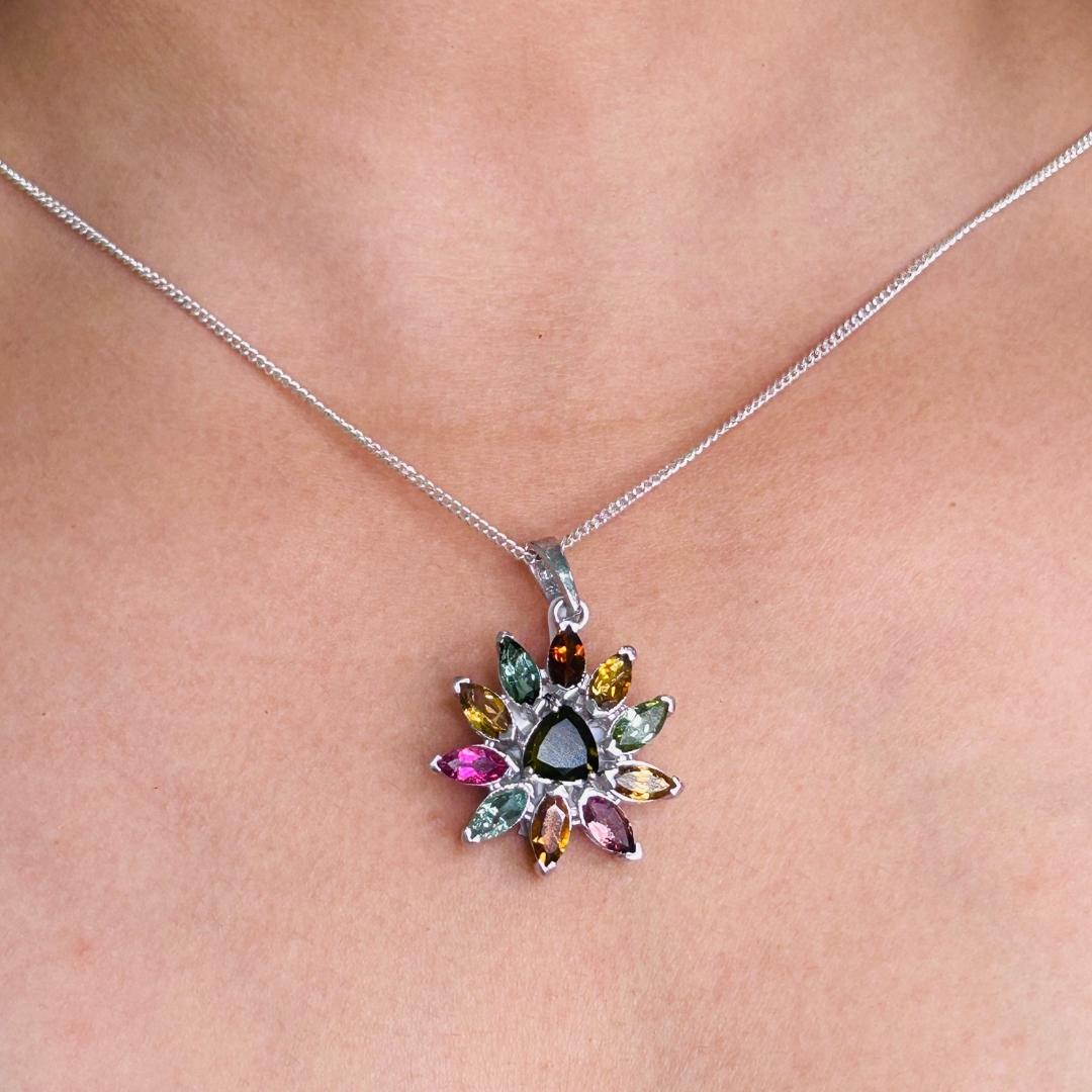 Multi Gemstone Encrusted Flower Sterling Silver Pendant in sterling silver studded with marquise, trillion cut multi gemstone. This stunning piece of jewelry instantly elevates a casual look or dressy outfit. 
Multi Gemstone enhances the