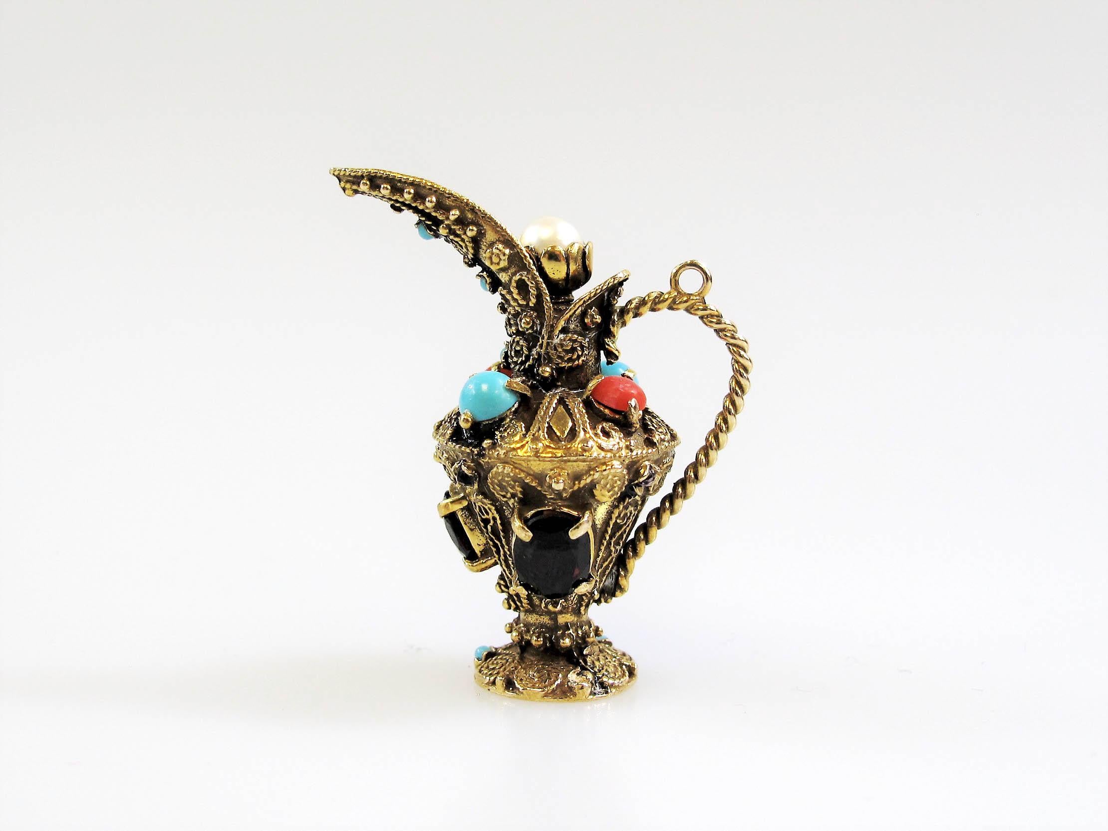 Unique multi-gemstone pitcher charm/pendant with incredible fine details. This colorful piece features an intricately carved 14 karat yellow gold pitcher with an elongated spout, twisted handle and a screw-off top. The pendant with is also filled
