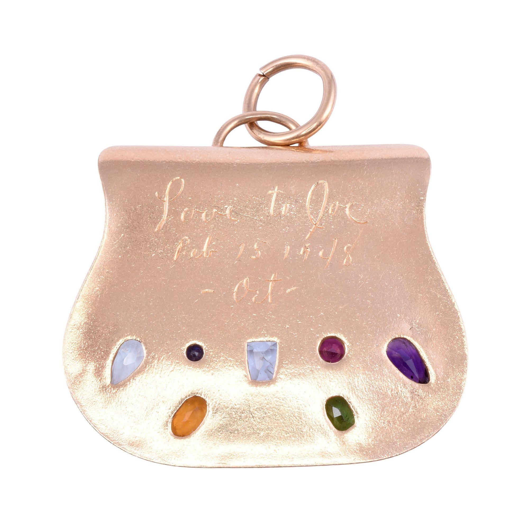 Vintage multi gemstone purse charm or pendant, dated 1948. This heavy 14 karat yellow gold charm or pendant in the shape of a purse features many gemstones including amethyst, pink tourmaline, peridot, aquamarine, and citrine. This vintage purse is