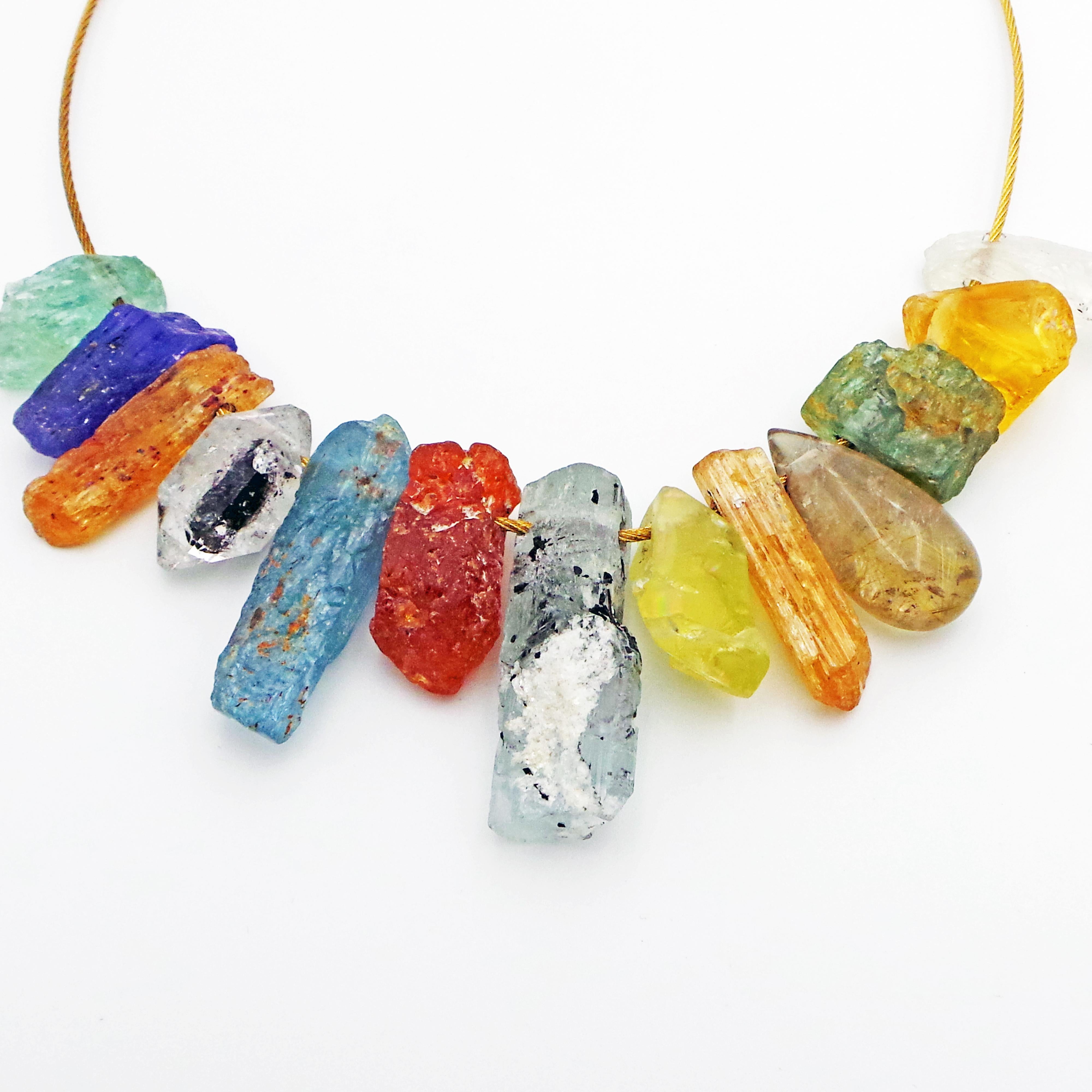 One-of-a-kind, colorful assortment of gemstones in their rough crystal form strung on a German-made 18k yellow gold woven wire necklace. Gold neck wire is finished with a 