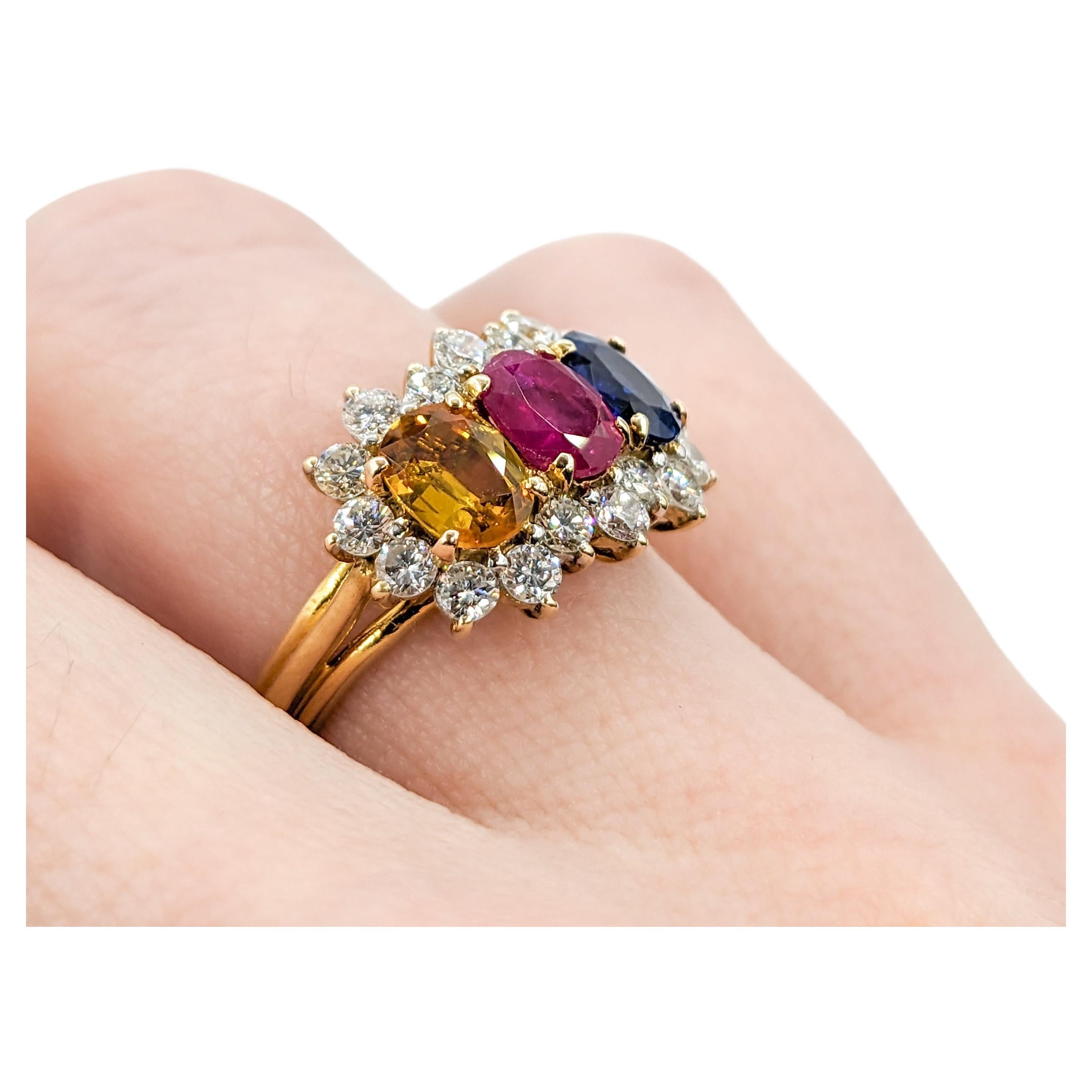 Multi Gemstone - Ruby, Blue & Yellow Sapphire Ring with Diamond Halo 18k

This exquisite multiple stone ring, masterfully crafted in 18K Yellow Gold, is a celebration of color and elegance. At its heart lies a captivating trio of gemstones,