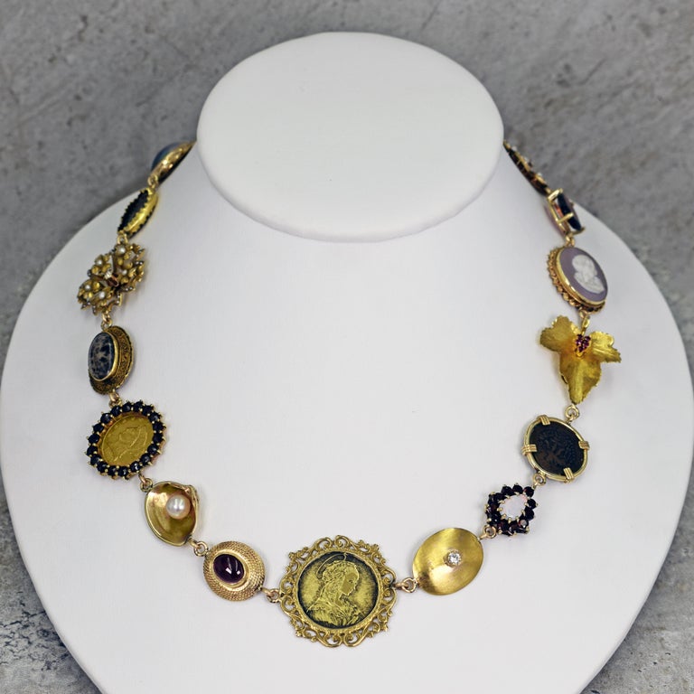 One-of-a-kind Vicki Orr 14k yellow gold Bohemian necklace with a variety of gemstones, vintage and antique jewelry components and an ancient coin. Necklace has 18 unique pieces, featuring Garnet, Bloodstone, Tahitian Pearl, Australian Matrix Opal,