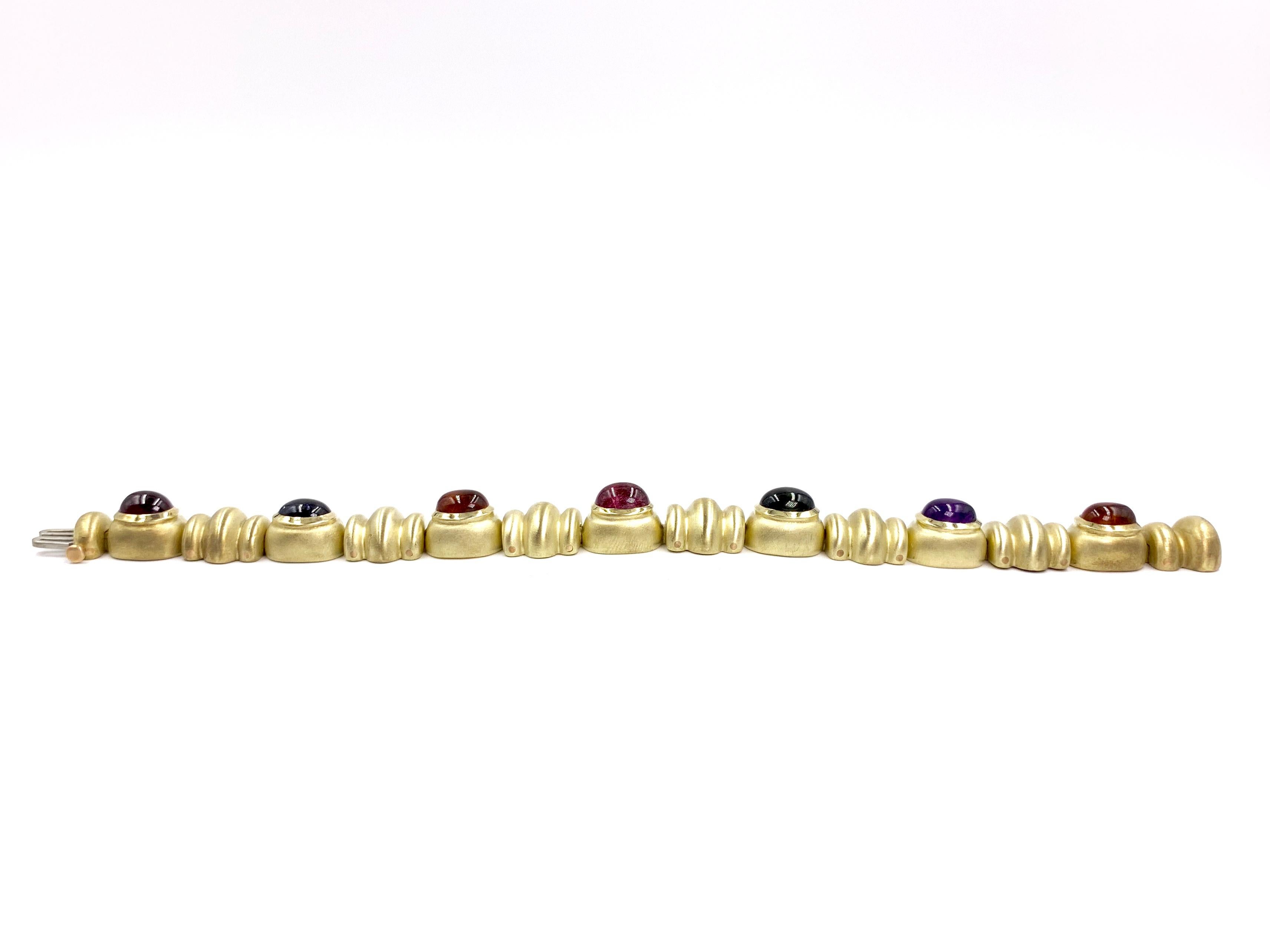 Made with superior quality by RAAFTY in a beautiful finished satin finished 14 karat yellow gold. This 11.5mm wide rounded and grooved bracelet features 7 bezel set cabochon cut oval semi-precious gemstones of the following: 2 citrine, 1 amethyst, 1