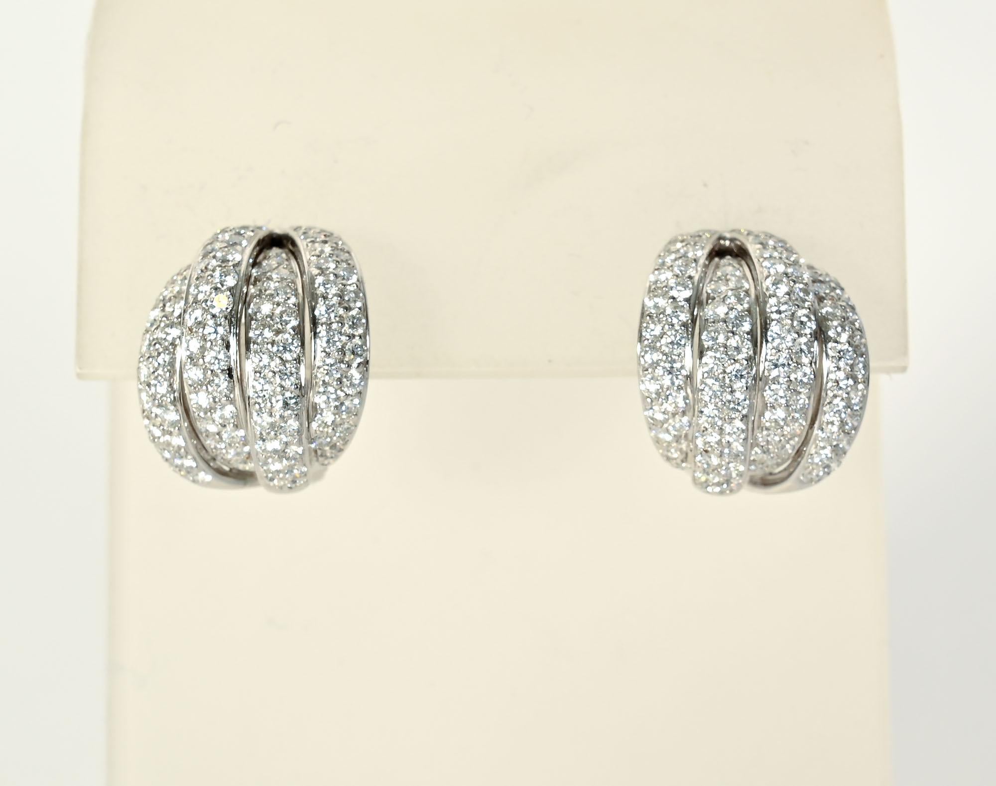 These diamond earrings are small but have a lot of impact. Four overlapping hoops of white gold show off the 100 diamonds that weigh a total of 2.5 carats. The stones are VS quality; H color. Backs are posts and clips that can be modified to all one