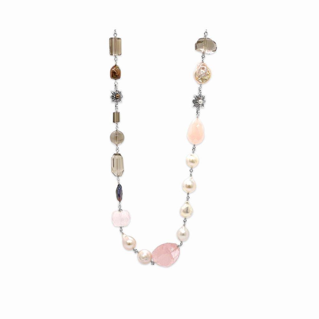 Indulge in the enchanting allure of our Multi-Hued Pearls Baroque and Keshi Pearls and Smoky and Rose Quartz Necklace in Sterling Silver. Each pearl, ranging in exquisite hues, is meticulously selected to create a harmonious blend of colors,