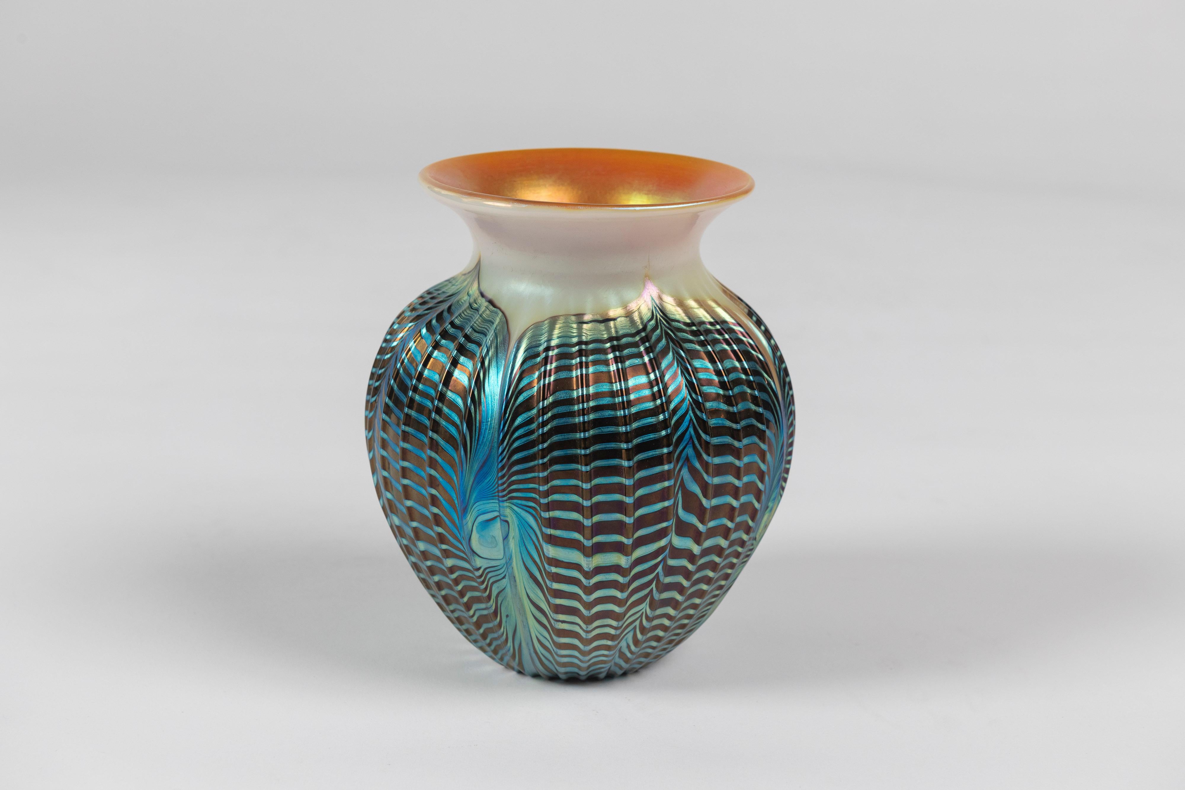 Our lustrous and iridescent vintage art glass vase by Lundberg Studios of California, is multicolored and hand blown. Add to collection or place as a single decorative.
 