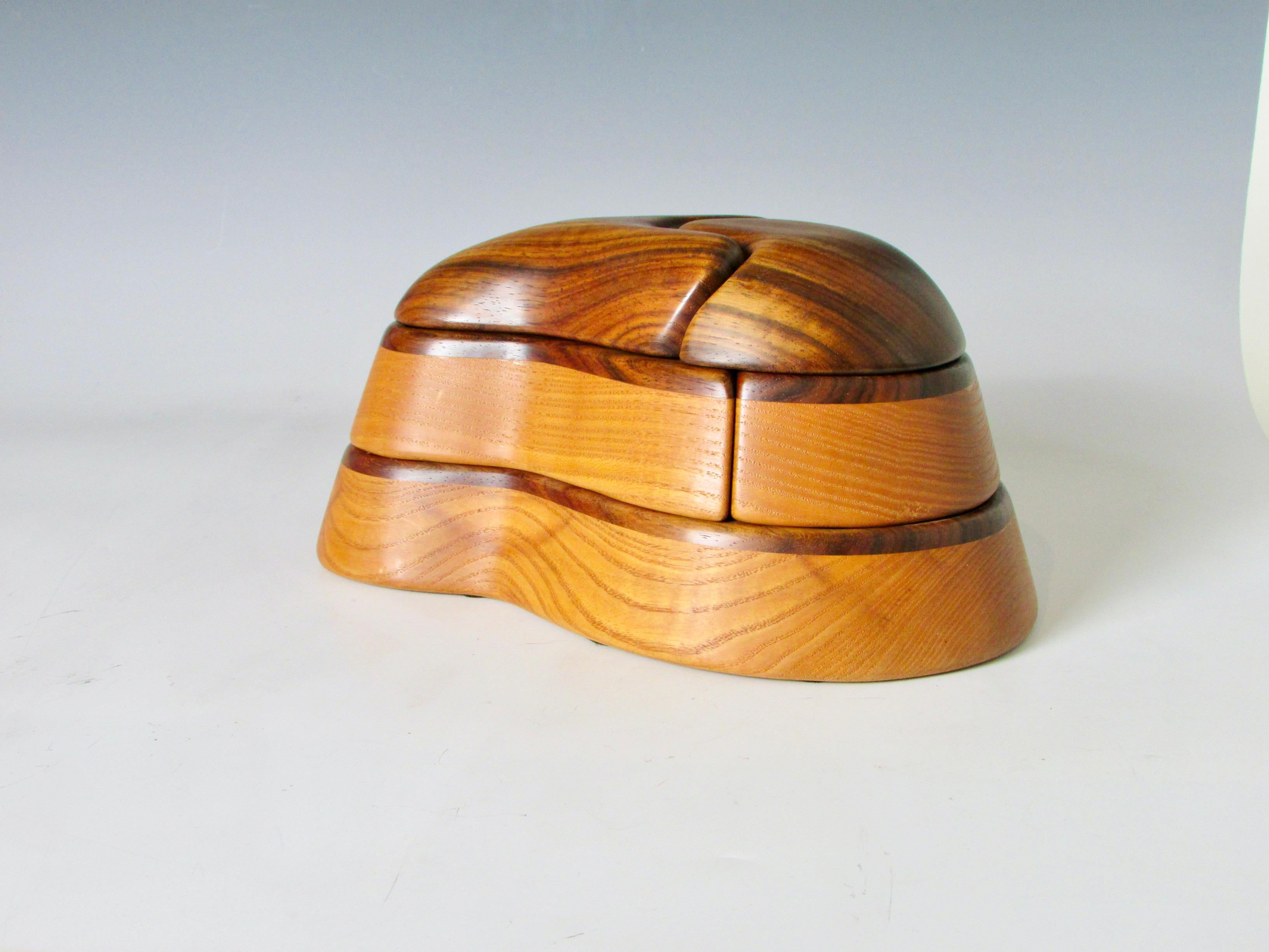 Multi hinged dresser box. Organic form of rosewood and ash. Signed Kevin Irvin 1981.