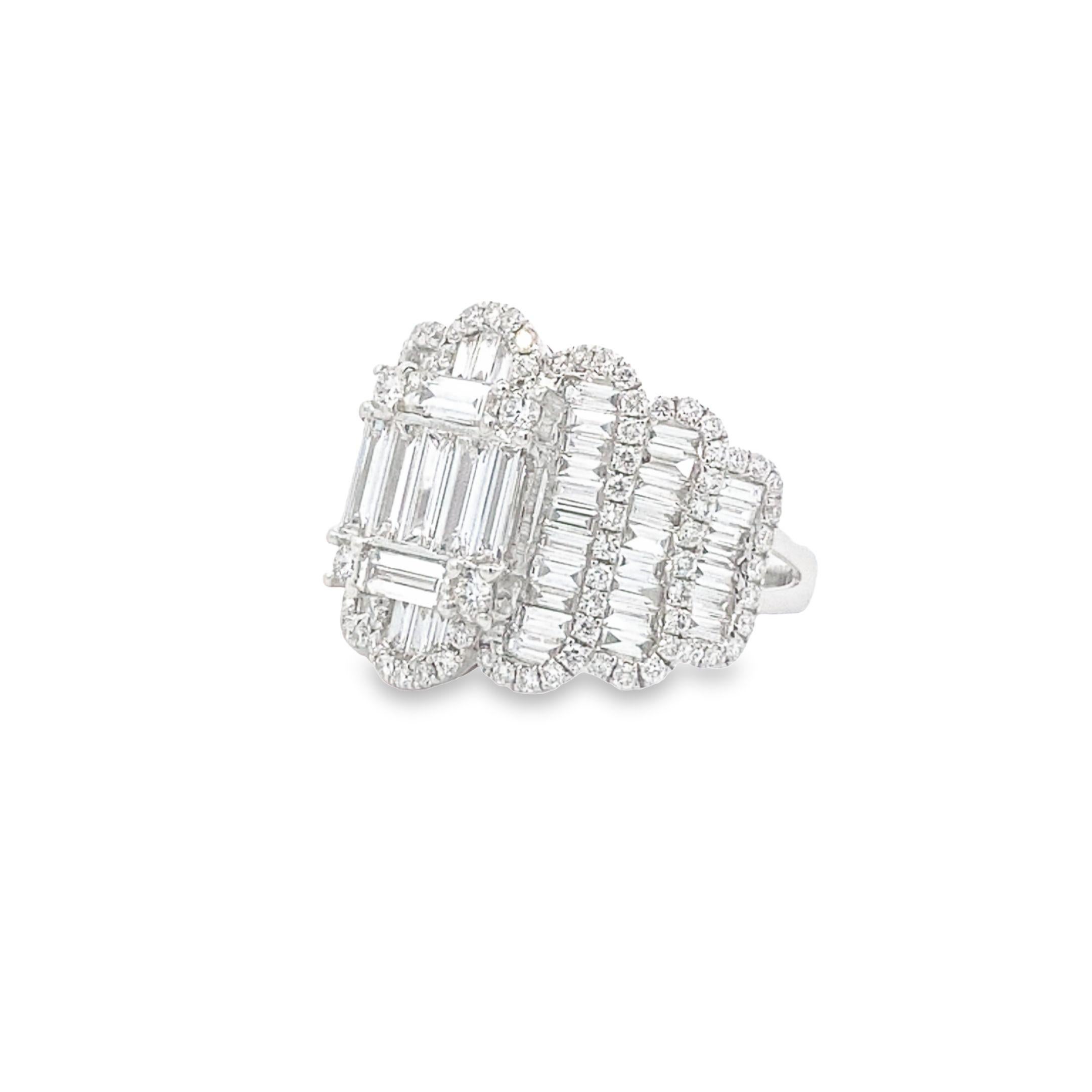 This bold ring, crafted in 18k white gold, features a dynamic layered design with 1.76 carats of channel-set baguette diamonds arranged in an elegant, sweeping pattern. The design is accentuated by 0.75 carats of prong-set round diamonds that