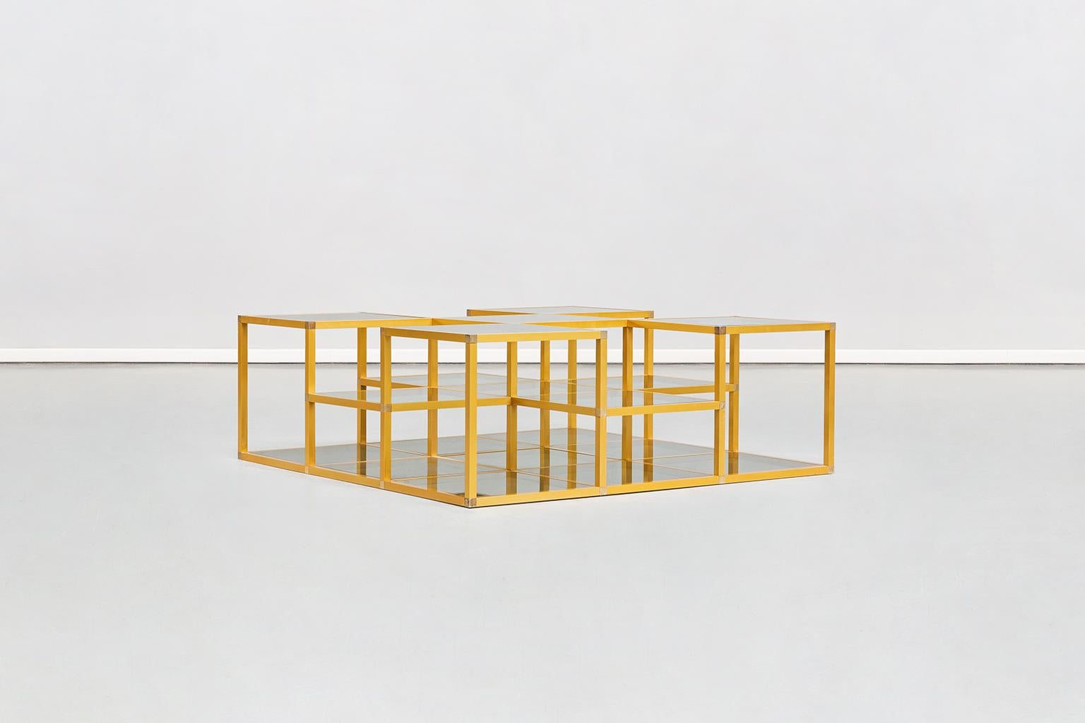 Multi-level Italian midcentury golden frame and smoked glass sofa table, 1960s
Multi-level Italian midcentury coffee table dating to the 1970s. Large structure with golden anodized aluminium frame, smoked multi-level glass tops, on the tones of