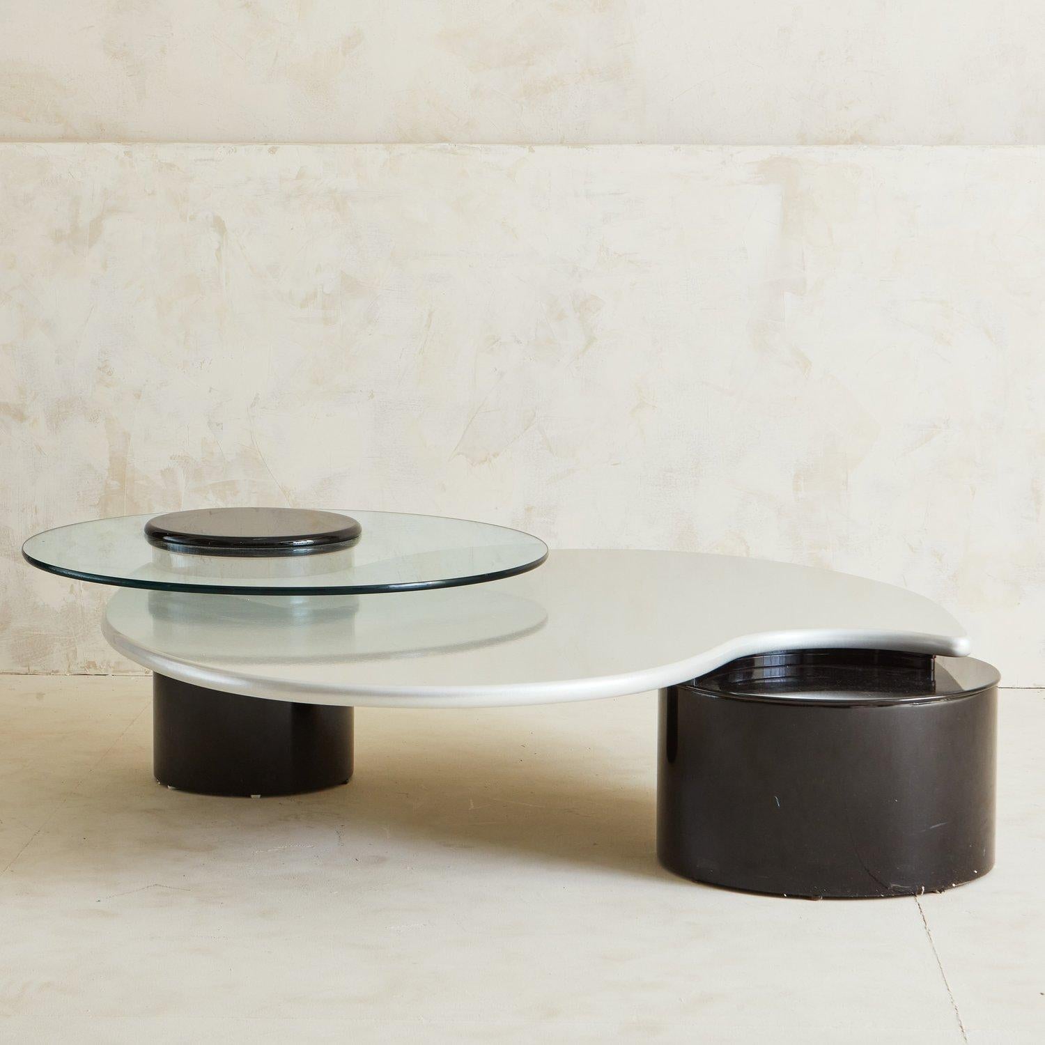 A Post Modern beauty by Canadian brand Rougier. This sculptural table features two large black laminate columns, a pearlized finish laminate table top and a rotating glass top that can swivel out (or be removed entirely).