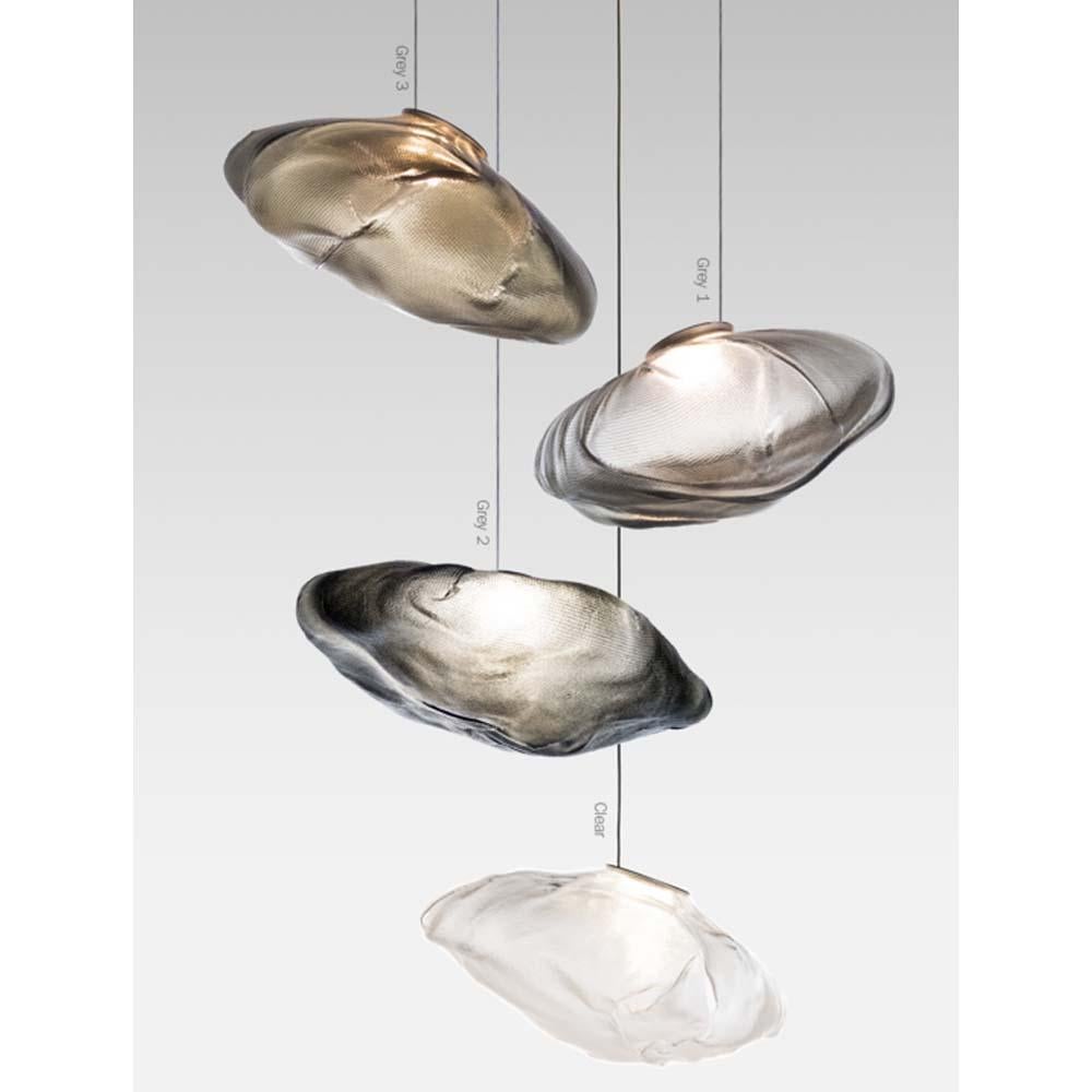 A multi pendant light suspension from 73 serie of Bocci.
Discover the 73 serie collection of multi-light suspensions from Bocci and designer Omer Arbel. 

73 results from blowing liquid glass into a folded and highly heat-resistant ceramic fabric