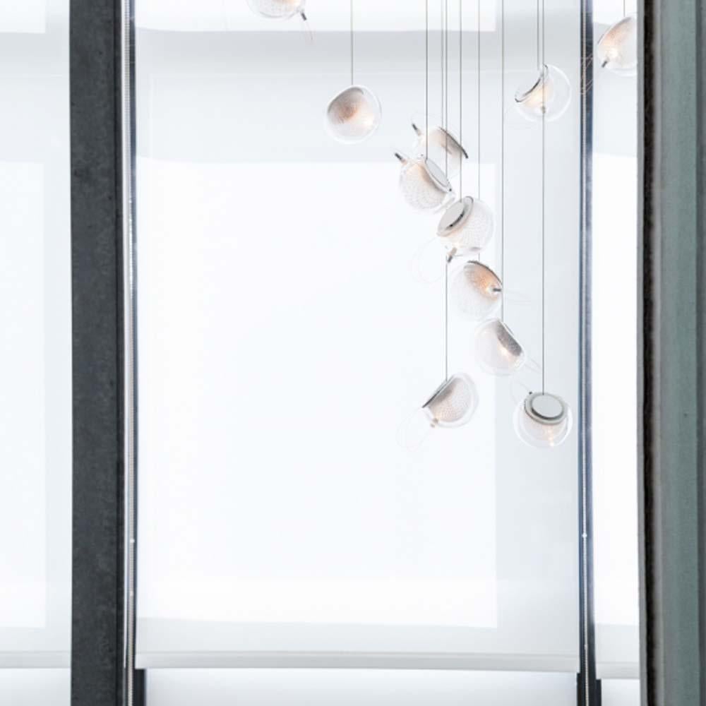 A multi-light suspension made of glass-blowing technique through copper mesh

This product corresponds to the reference 76.7 : seven pendant fixture, 203mm diameter brushed nickel round canopy.

The elegance of the design of the 76 Serie comes