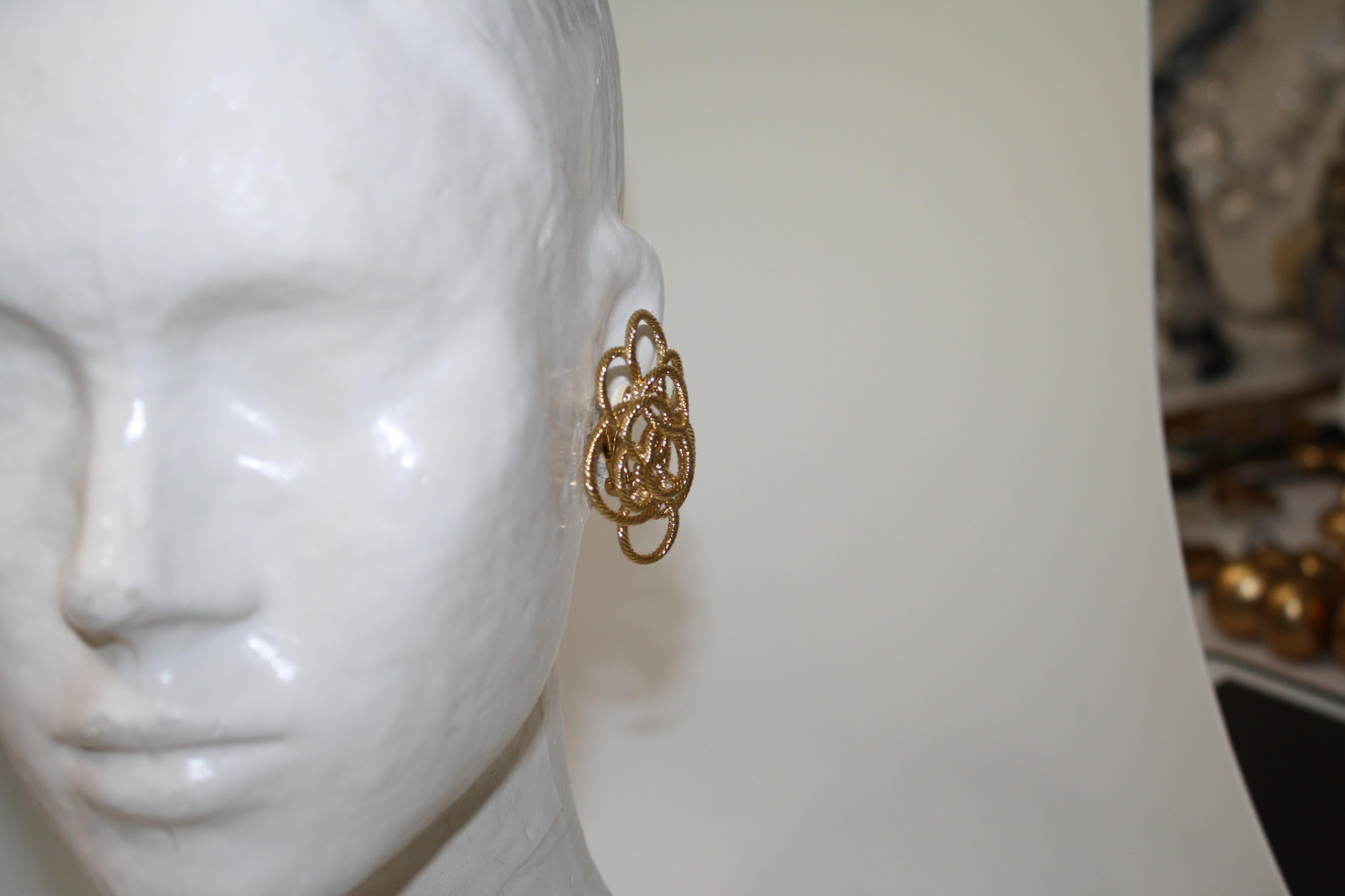 Bronze dipped in 24-carat gold braided . Clip earrings 
An intricate design of different circles create an amazing statement earring. 
Sylvie Blet, the designer was Robert Goossens personal assistant in all of his creations. She worked by his side