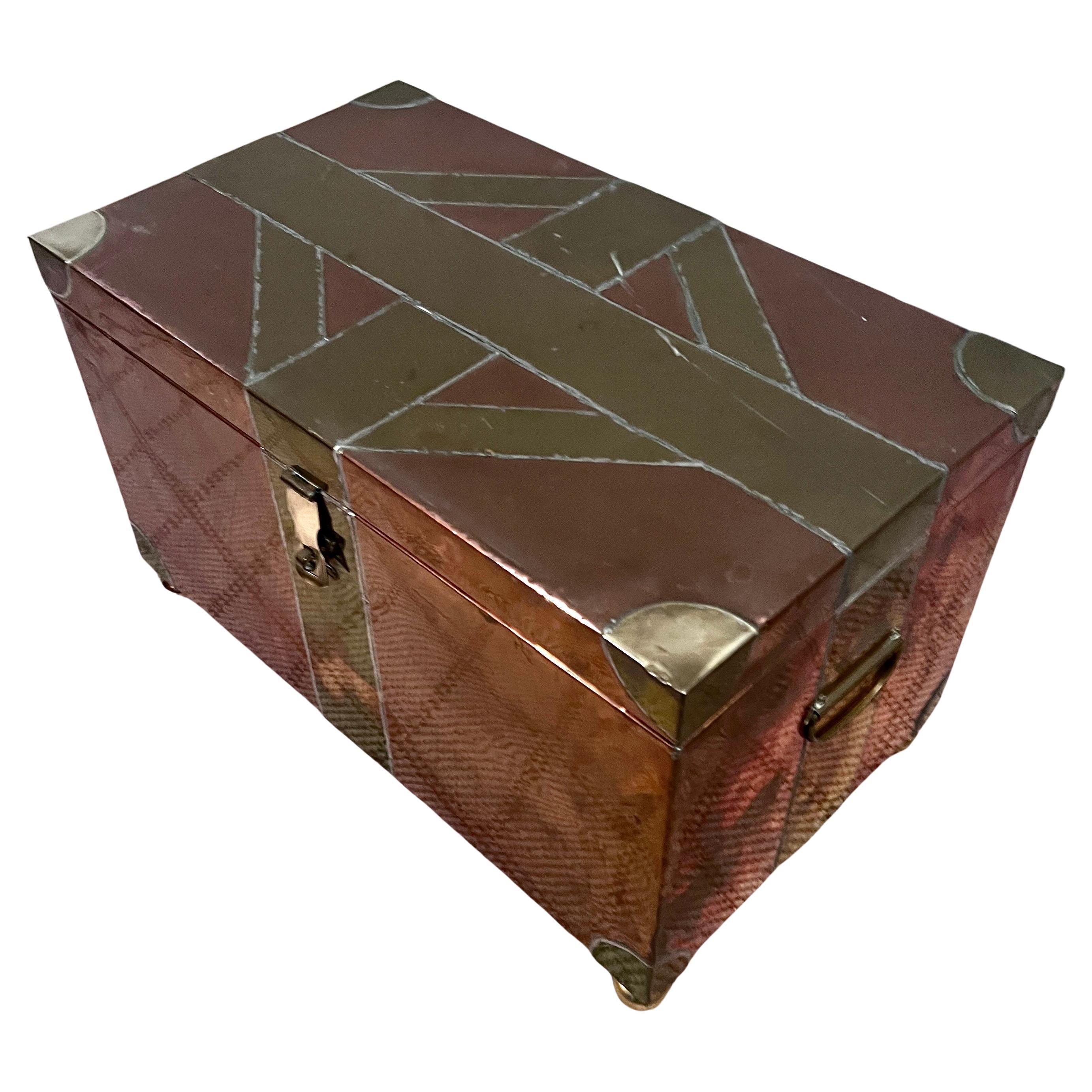 Muti-Metal Hinged box of Brass and Copper.  The piece is of the Brutalist Style and its hand Crafted qualities of welded or soldered pieces of Metal to form a geometric pattern with Brass Corners and polished brass bun feet.

A compliment to many