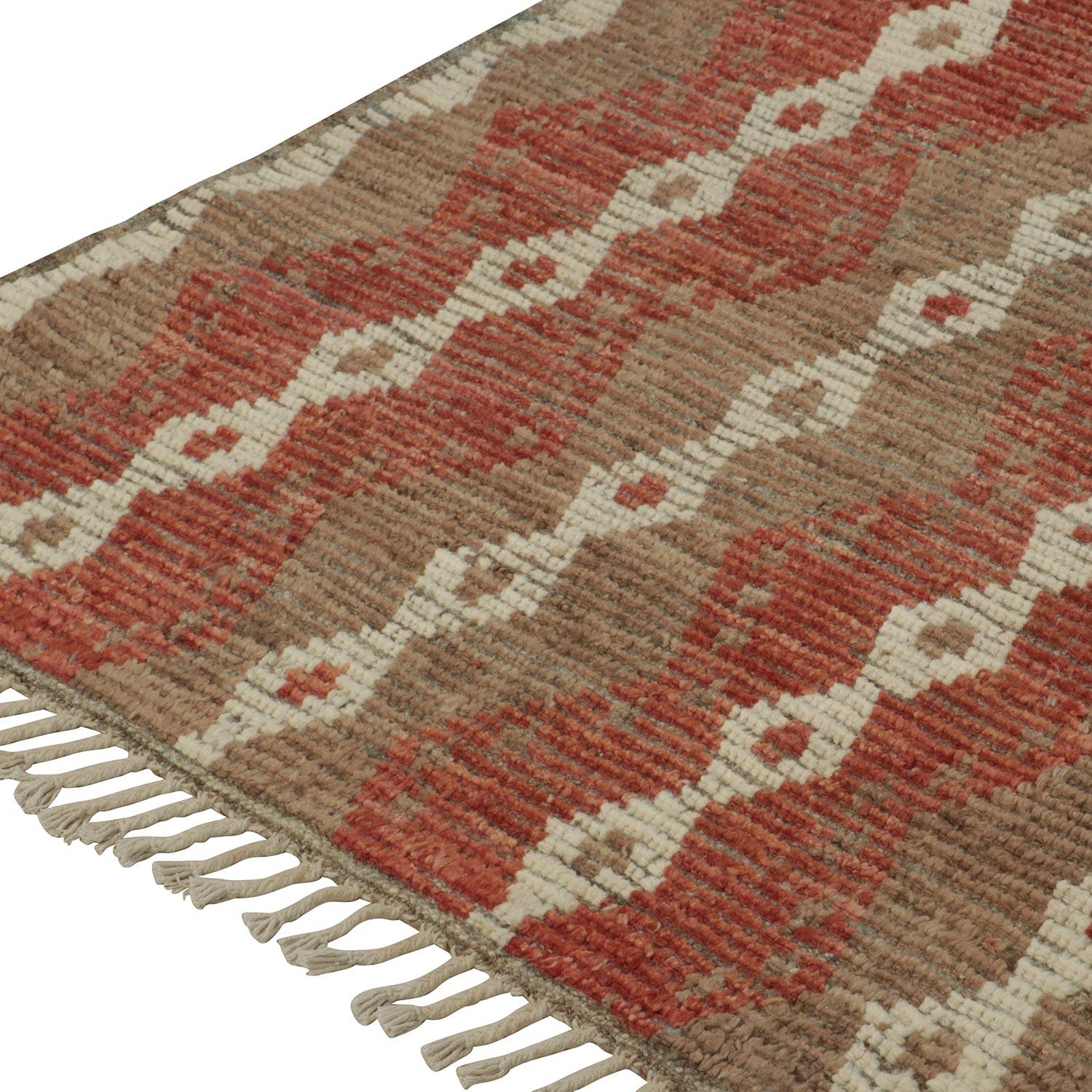 Linear form creates an intricate and elongated pattern filled with diamonds and stripes finished with a classic border in this Multi Moroccan Wool Rug - 8'3