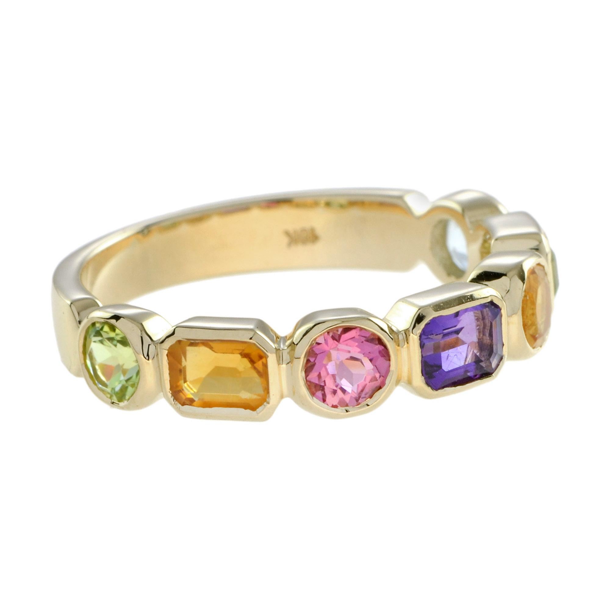 A fascinating combination of a very different colored sparkling gemstones are brought together with impact in these multi gemstone ring. A pale blue topaz, stunning purple amethyst, lovely pink topaz, citrine, and cool green peridot in half eternity