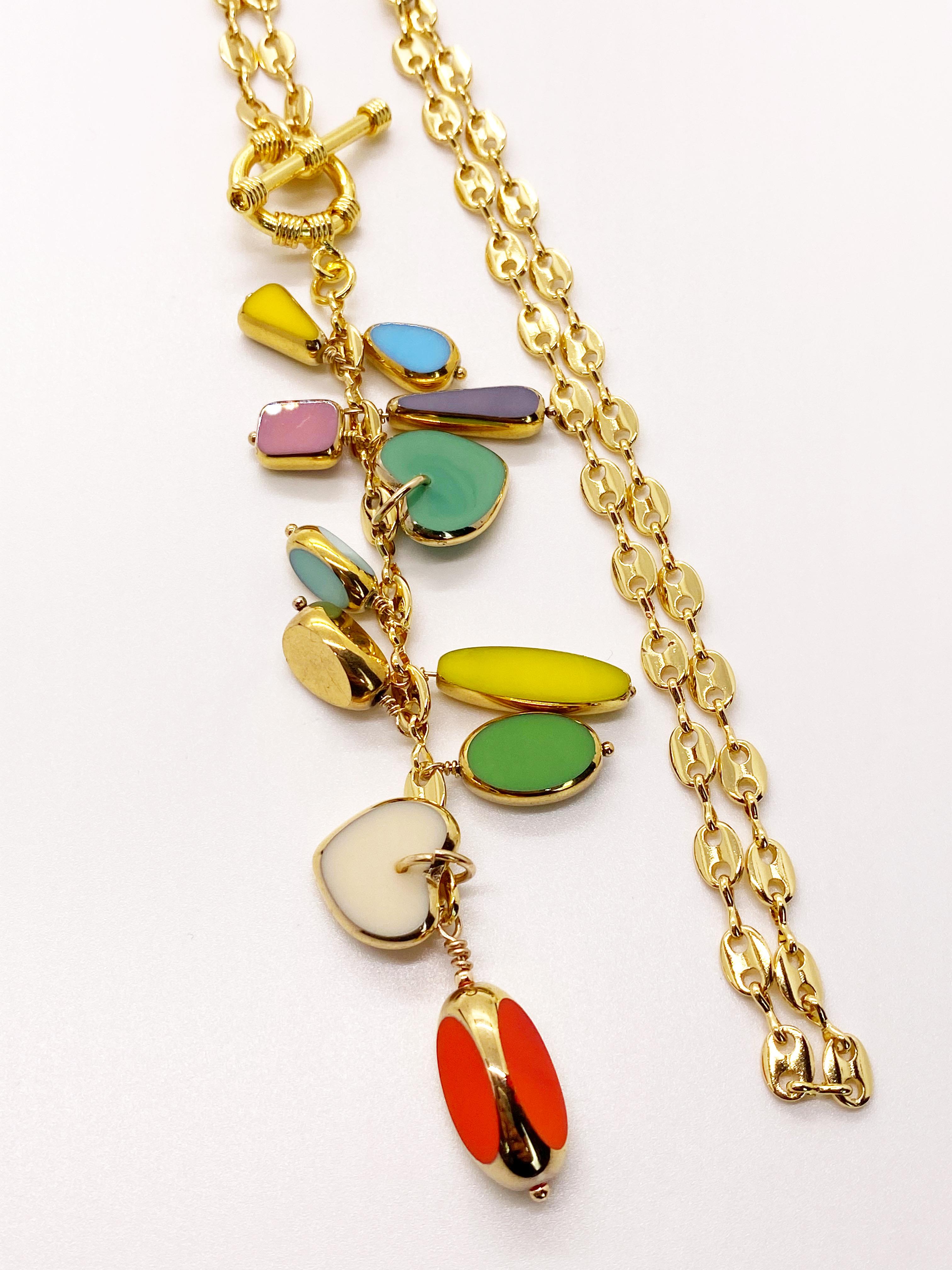 24K gold-filled chain and 18K gold-filled toggle clasp, adorned with 11 colored 24K gold edge German vintage glass beads. The necklace measures at 18 inches with about a 4 inch drop. 
*Charms will vary*

The 24K gold edge German vintage beads are