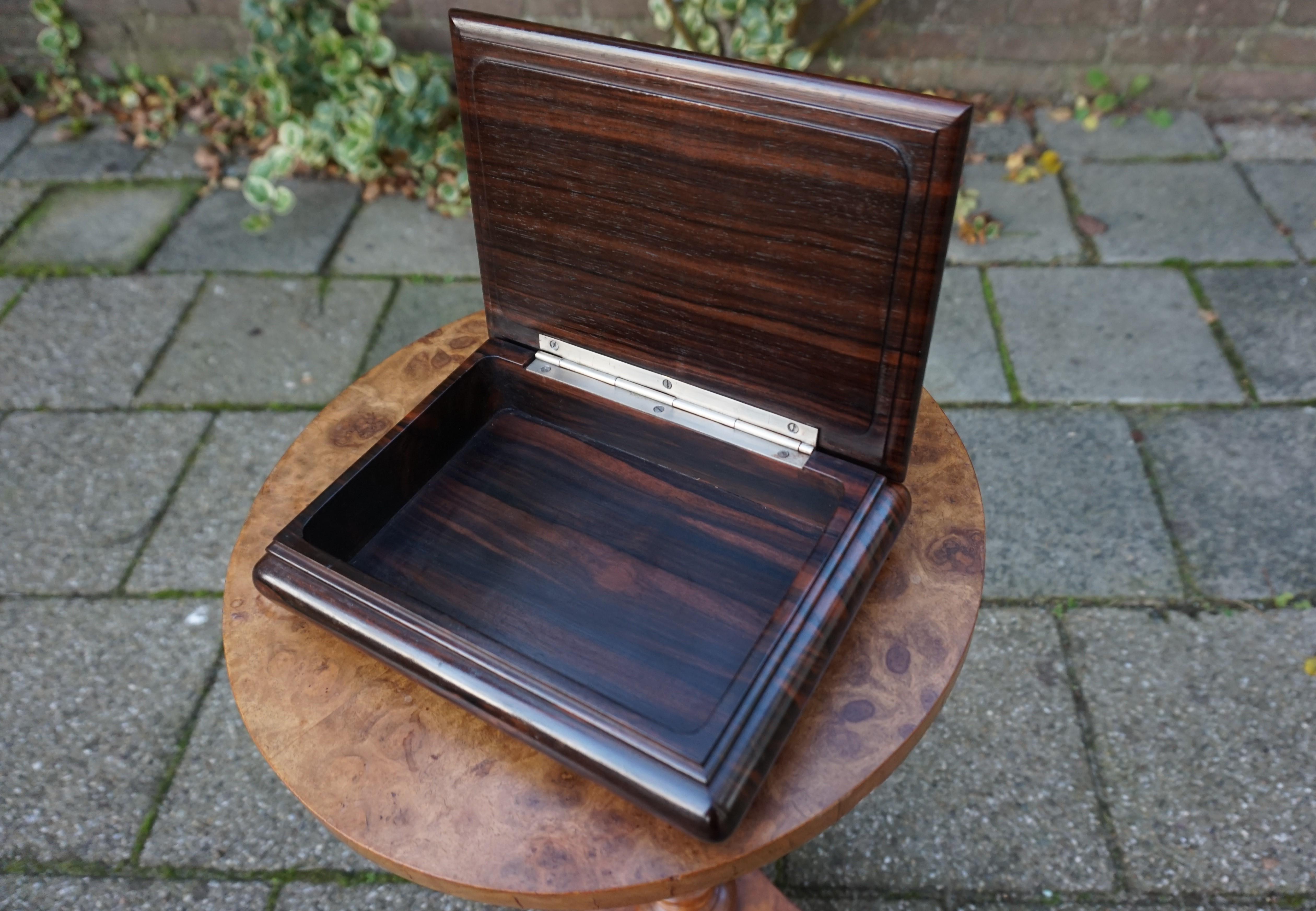Stunning shape and practical size coromandel wood box from the Art Deco era.

This exceptional and highly stylish antique box too is even better looking in real life. Completely handcrafted out of the most beautiful coromandel wood only, this work