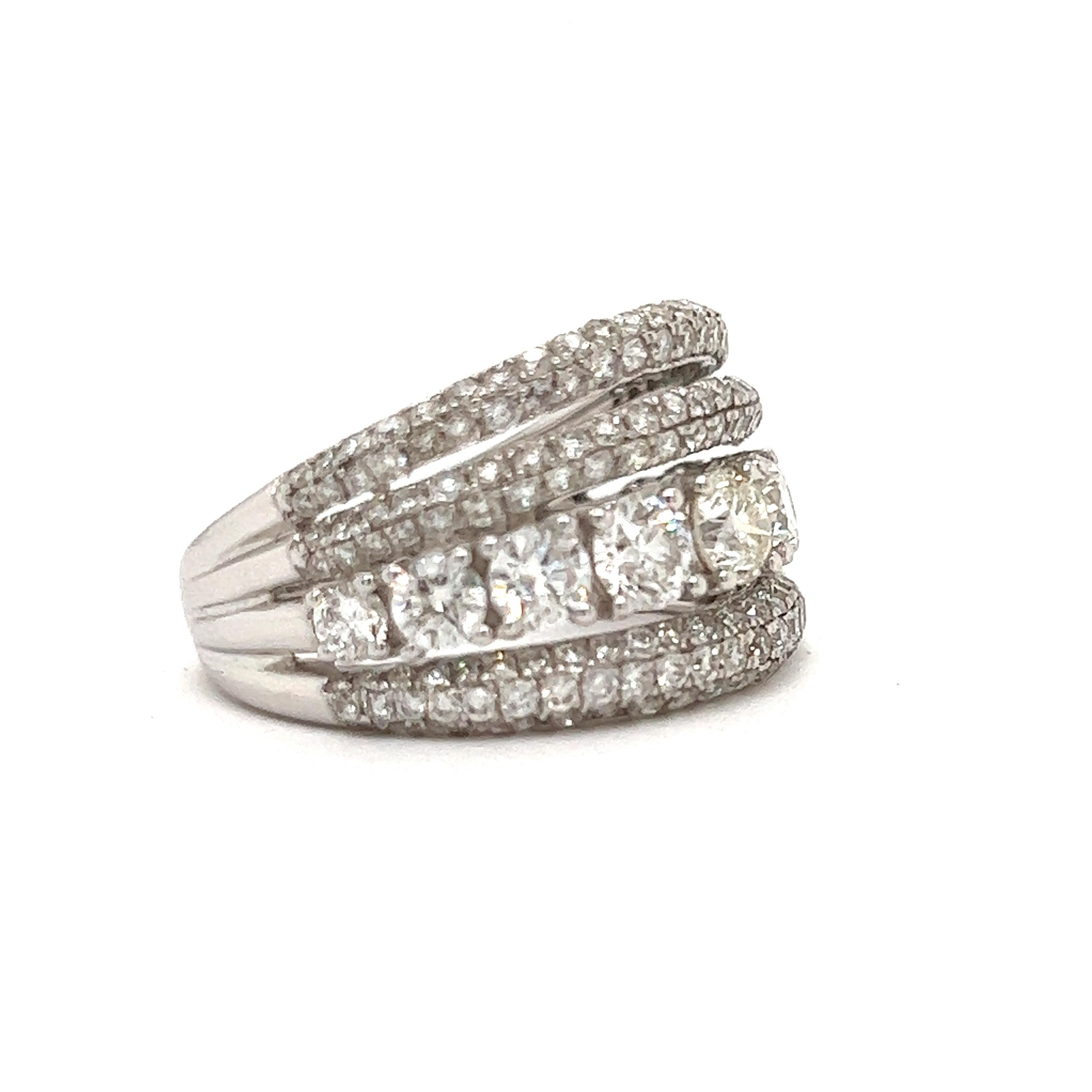 This stunning multi row designer band is 2.58 ctw in shimmering round and pave diamonds, a total of 174 diamonds.  Set in 5.50 grams of 18K white gold this outstanding ring makes a statement.  Perfect for an anniversary gift, push present or wedding