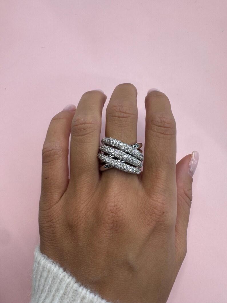14 Karat white gold crossover ring featuring three rows of diamonds containing 183 round brilliants weighing 1.61 carats. 

More Fashion Rings in Stock.
Message for pictures and details. 