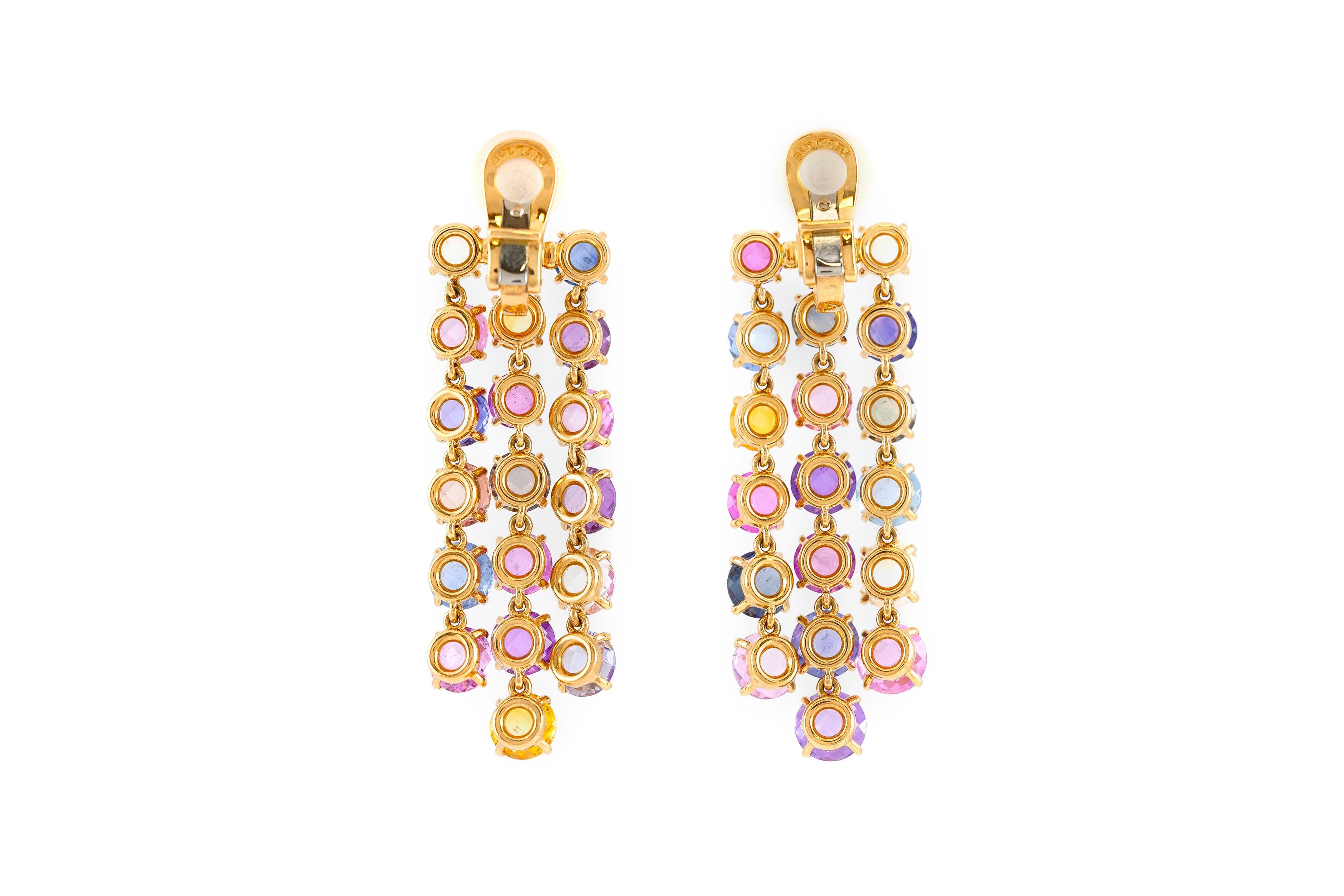 The earrings is finely crafted in 18k yellow gold with three lines of multi color sapphire.

Sign by Bvlgari.