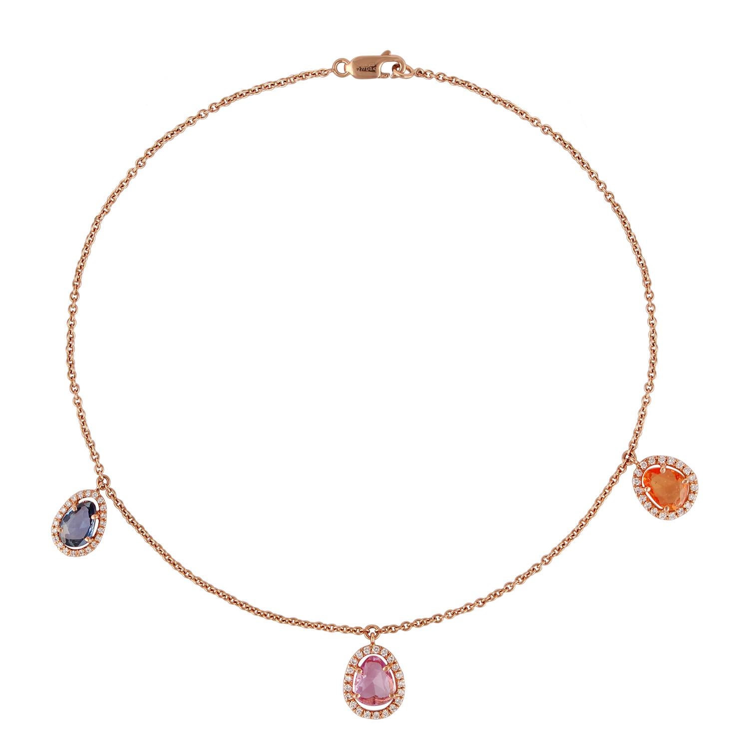 This is an elegant necklace with a multi-colored sapphire surrounded by the round-shaped diamond cluster. This necklace is entirely studded in 18K rose gold. The multi-colored sapphire weight is 2.77 carat, diamond weight is 0.43 carat, this