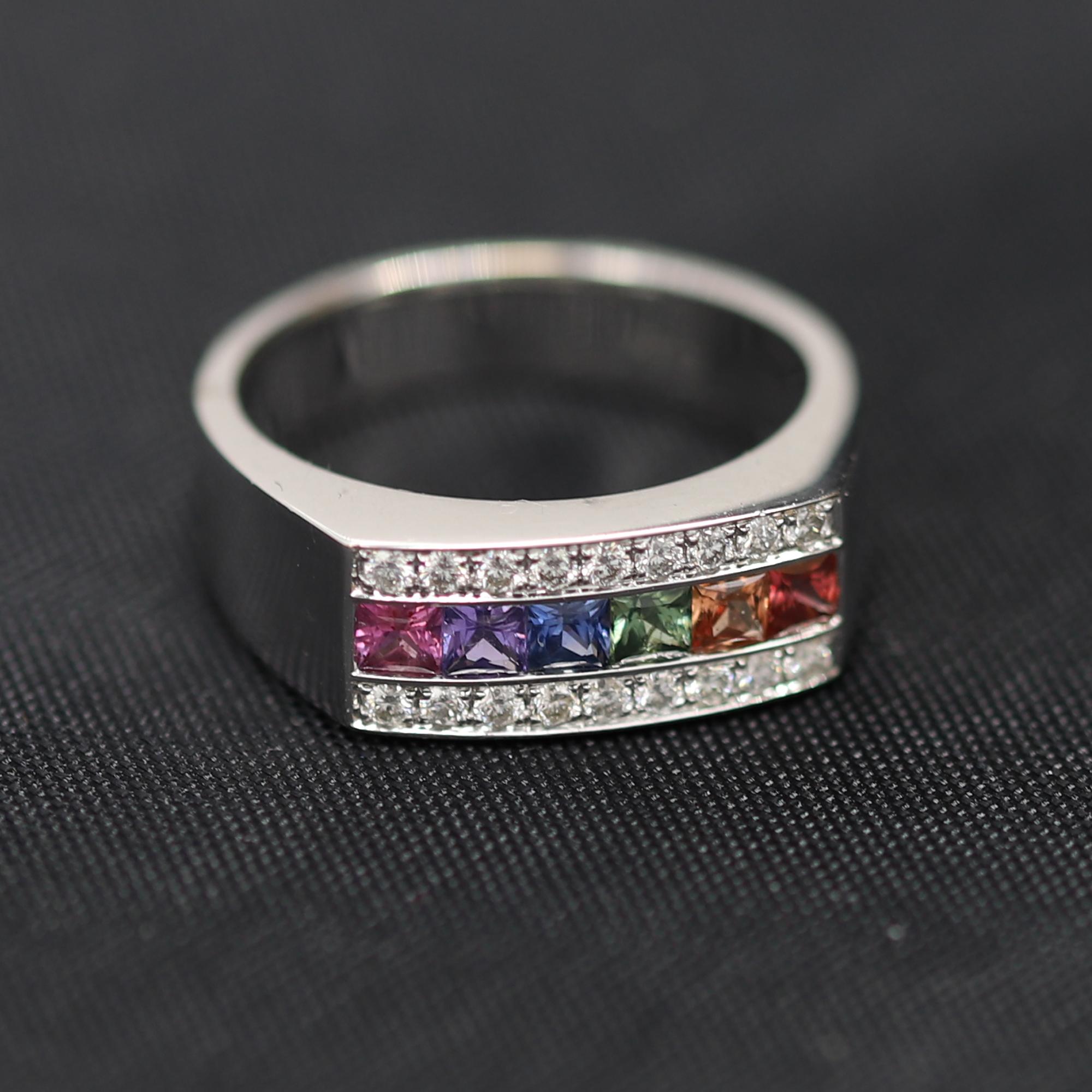 Brilliant Multi Sapphire Band,
Square cut stones set in a channel settings.
Multi Color stones  total 0.77 carat - mix brilliant colors.
Total Diamonds 0.26 carat GH-SI
18K white gold 6.5 grams
Finger size 6.75
Band width approx 7 mm
Each stone is