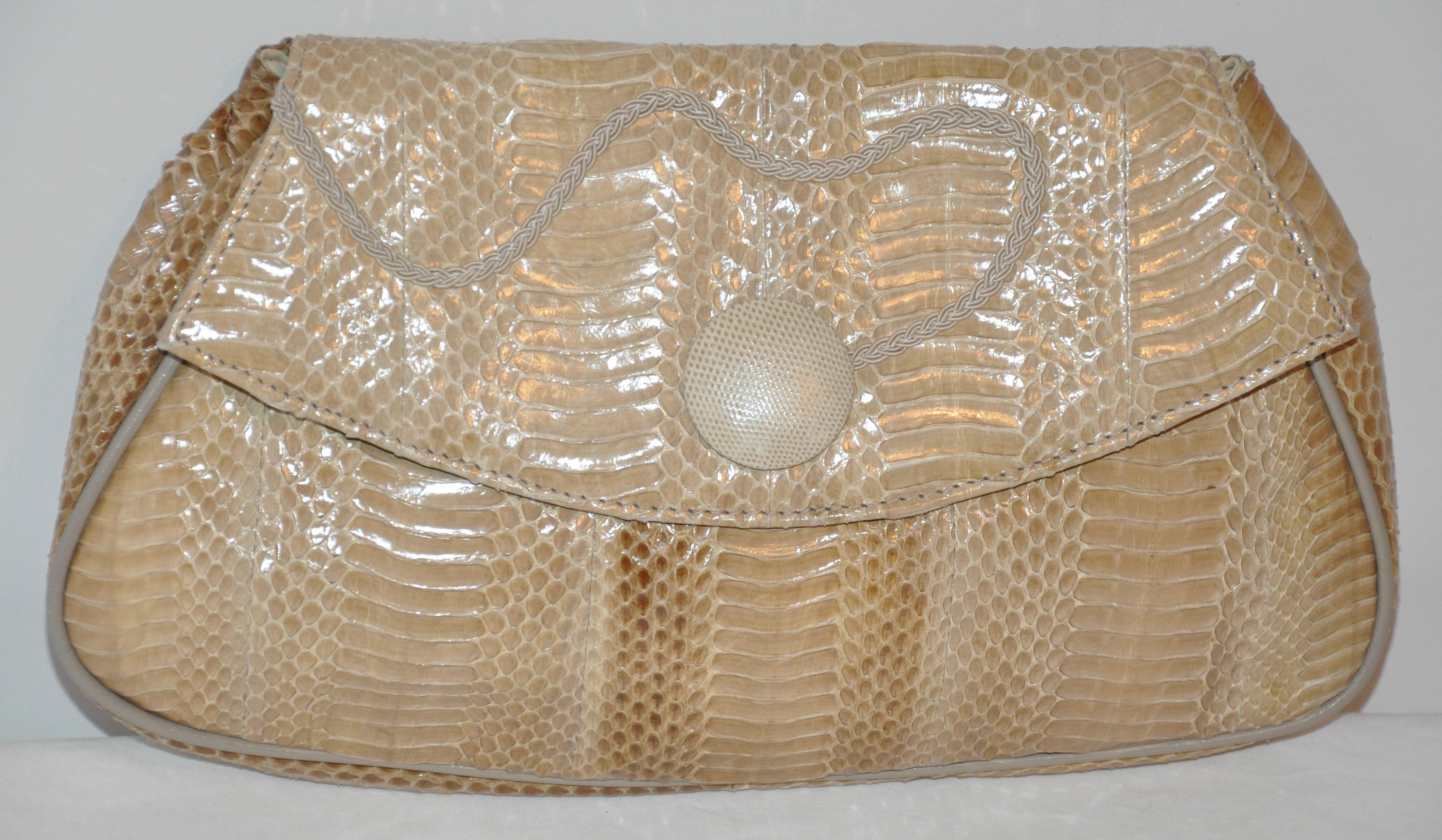     This wonderfully elegant combination of beiges and brown snakeskin clutch has an optional shoulder strap nicely tucked inside the interior zippered compartment. Clutch measures 13 inches in length, 7 1/2 inches in height and 2 1/2 inches in