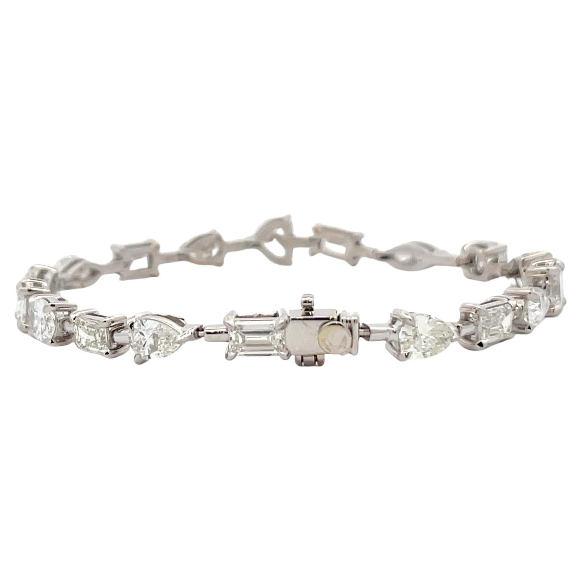 IGI Certified, 18 Karat White Gold tennis bracelet featuring 18 multi-shape diamonds weighing 9.73 Carats.
Average diamonds 0.50 pointers
This diamond contains 6 Emeralds, 6 Pears, 2 Ovals, 2 Marquise, 1 Heart, and 1 Square Modified