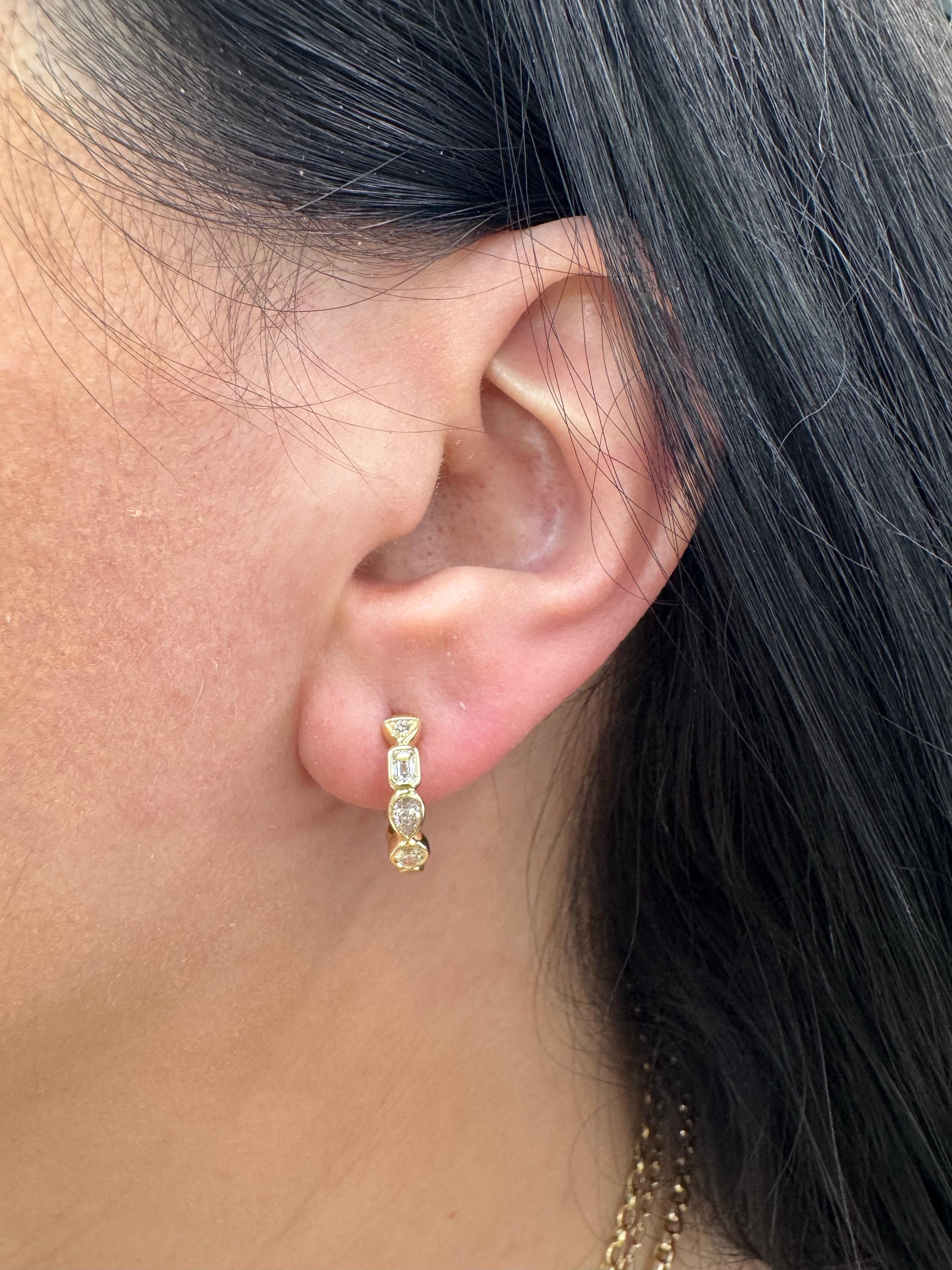 14 Karat yellow gold huggie hoop earrings featuring multi-shape diamonds, including Round, Emerald, Pear cut diamonds weighing a total of 0.50 carats.

More huggie earrings in stock.
Message for more pictures and details. 