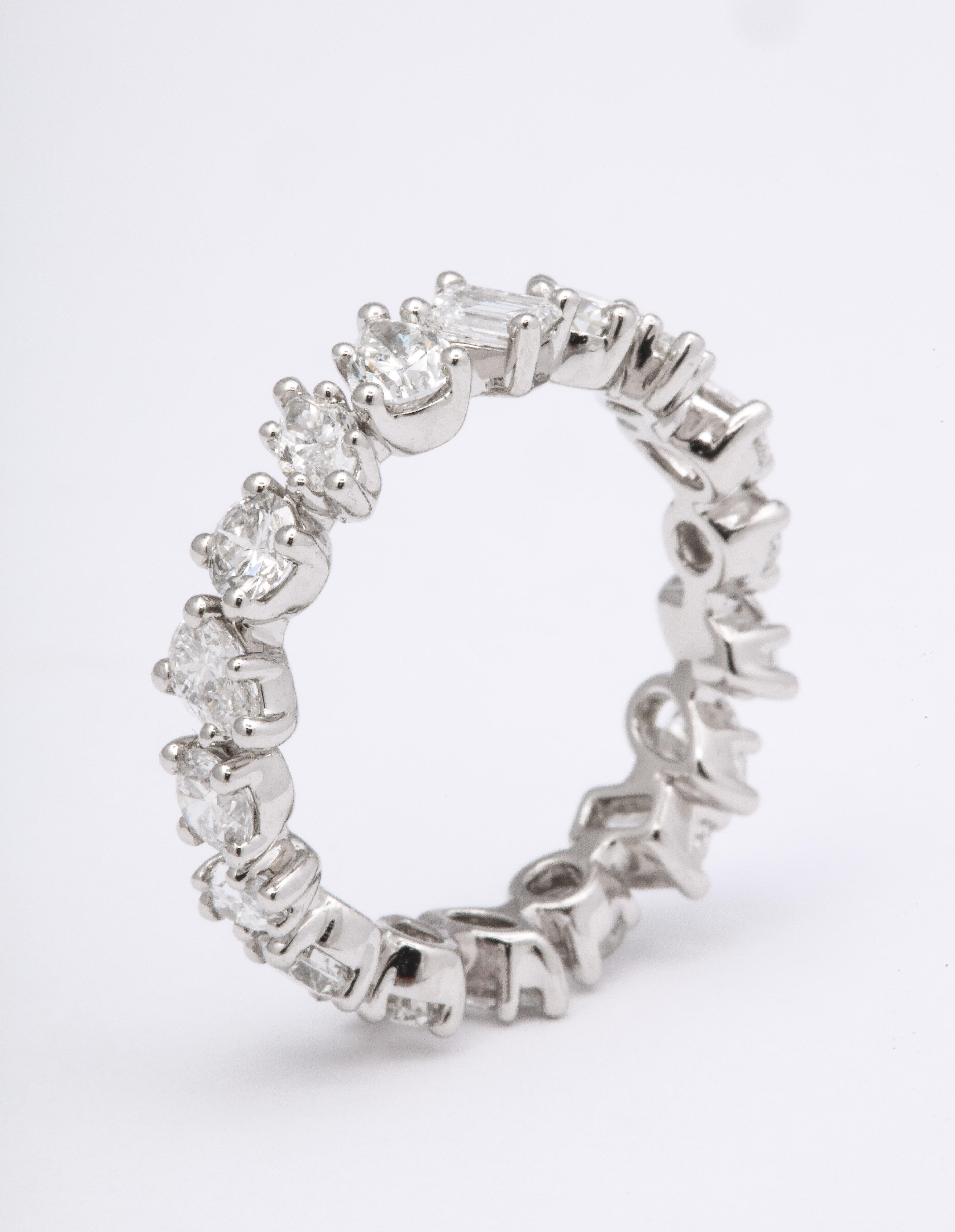 
Fabulous worn alone or stacked.

Eternity band featuring white round, pear shape, marquise and emerald cut diamonds. 

2.66 carats of diamonds set in platinum

Currently a size 6, but can be slightly adjusted or ordered in any size. 

4.8/4.9 mm
