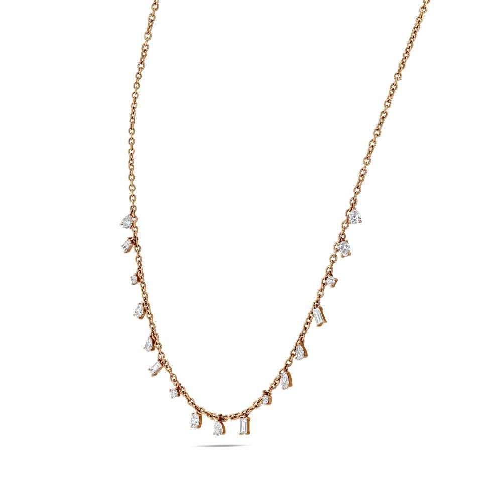 This prong set hanging diamond necklace is a dazzling contemporary piece. The necklace consists of 17 multi shape diamonds all of which are held in their own 18 karat rose gold prong basket. These baskets are then spread out and hung along the front