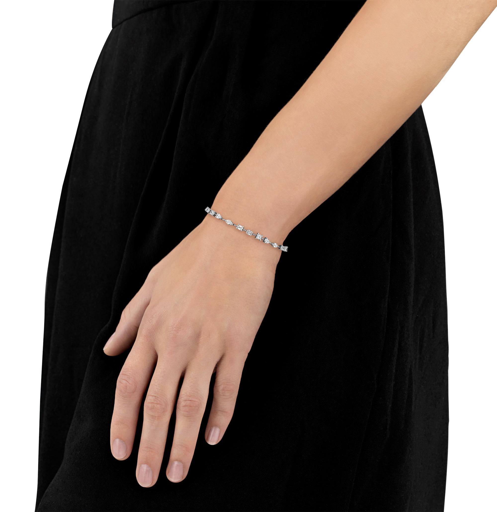 This stunning multi-shape diamond tennis bracelet features twenty-three diamonds of varying cuts – marquise, pear, emerald and oval. Totaling 4.98 carats, the brilliant array of diamonds highlights the stunning diversity of the timeless gemstone.