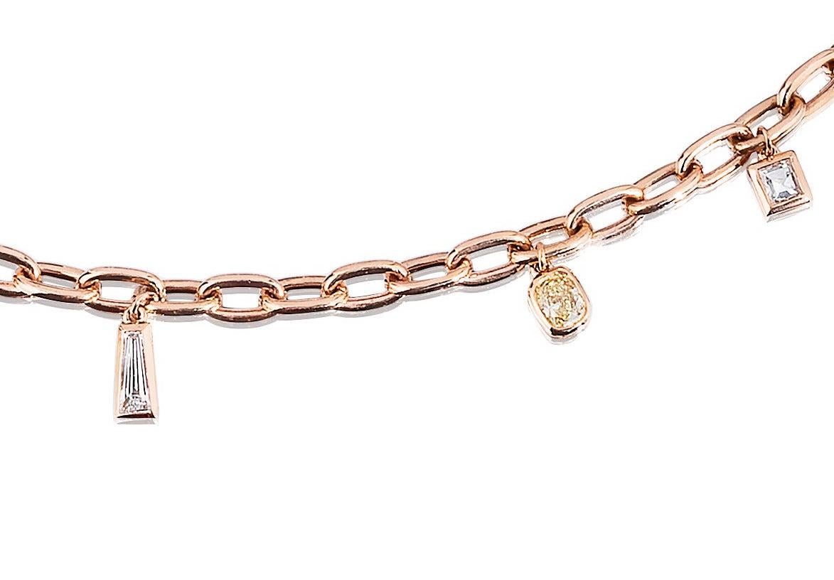 Solid Link bracelet set with 7 Multi Shaped White and Yellow Diamonds in Bezel Set Charm Style.
Great for Stacking with a watch a bangle/bracelet or with multiple of these Bracelets as shown.
1.56 Carats.
18 Karat Rose Gold.
Lobster Claw