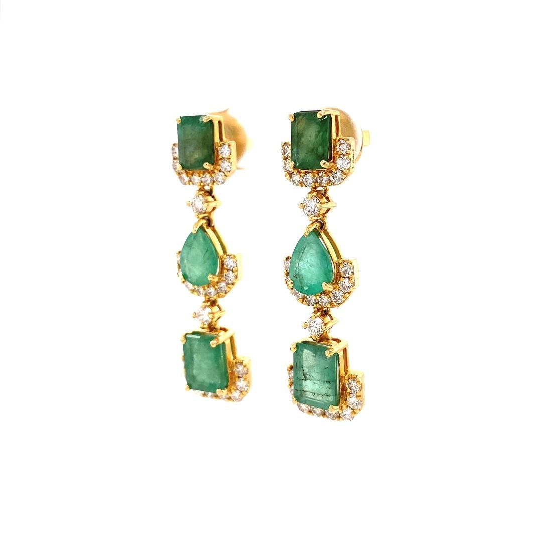 These diamond earrings with multiple shaped emeralds are a striking piece of jewelry that combines the timeless elegance of diamonds with the rich green color of emeralds. These earrings feature a dangle design, with diamonds set in a pattern around
